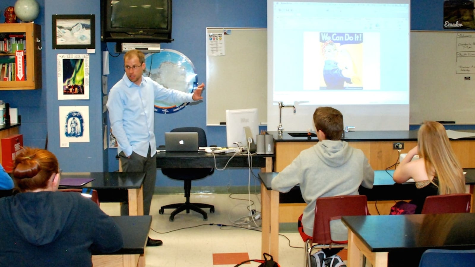 Highlands Ranch High School science teacher Bob MacArthur leads a class discussion May 16 on propaganda art. His ninth grade science class was asked to design a propaganda poster in support of an energy source they have been studying.