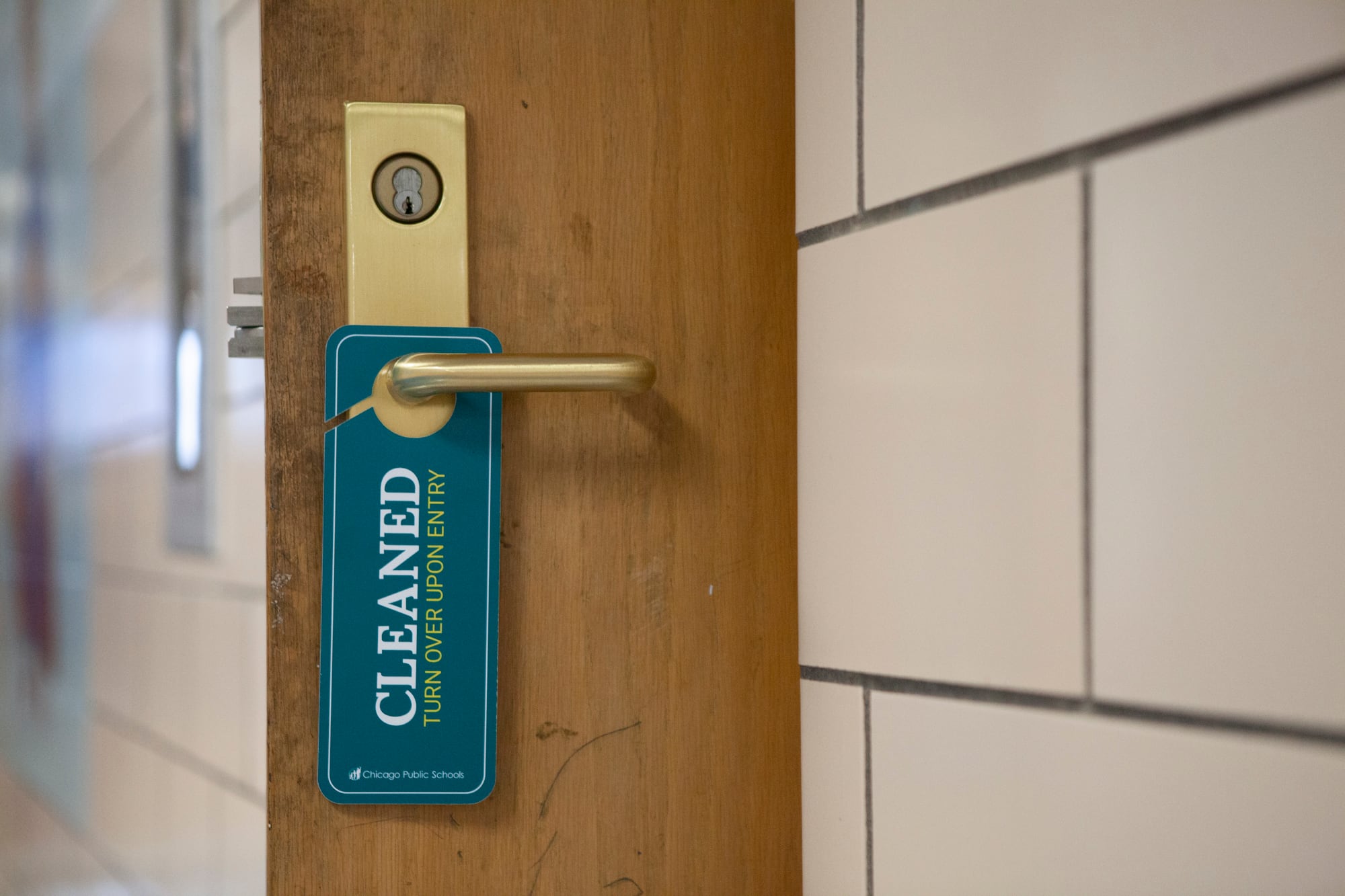 A sign hanging on a doorknob that indicates that the room has recently been cleaned.