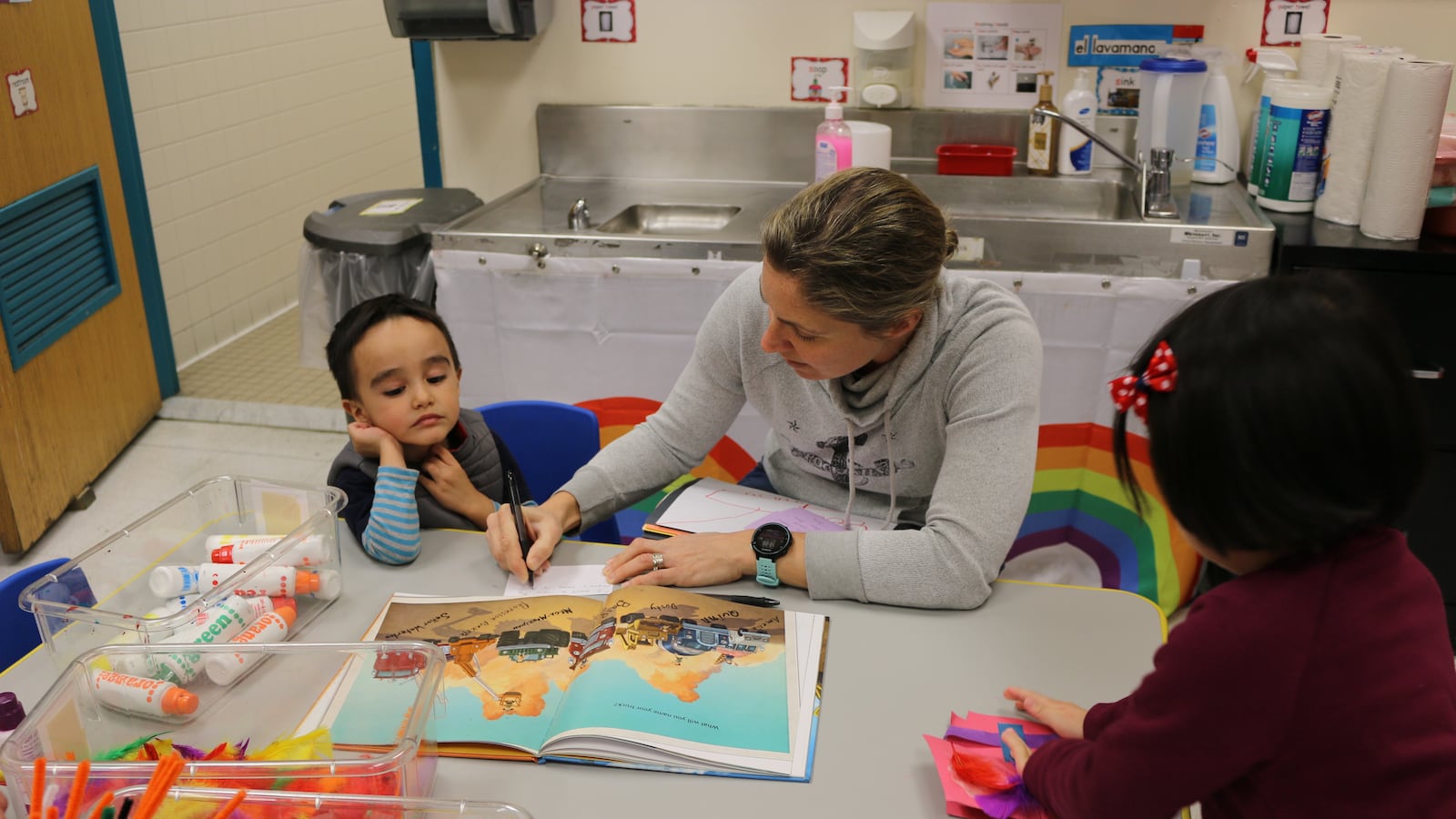 Teacher Flo Evans works with a pre-K student at The Renaissance Charter School in Jackson Heights, Queens. The school is one of the few charters that participates in the city's pre-K for all program. Charter operators say funding and facilities issues are main deterrents.