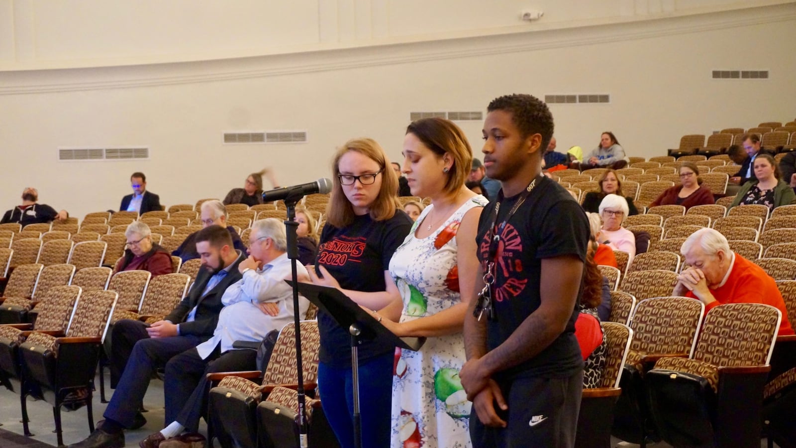 brittany yanasak, a reading specialist and English teacher from Manual High School, brought two students to the microphone as she spoke.