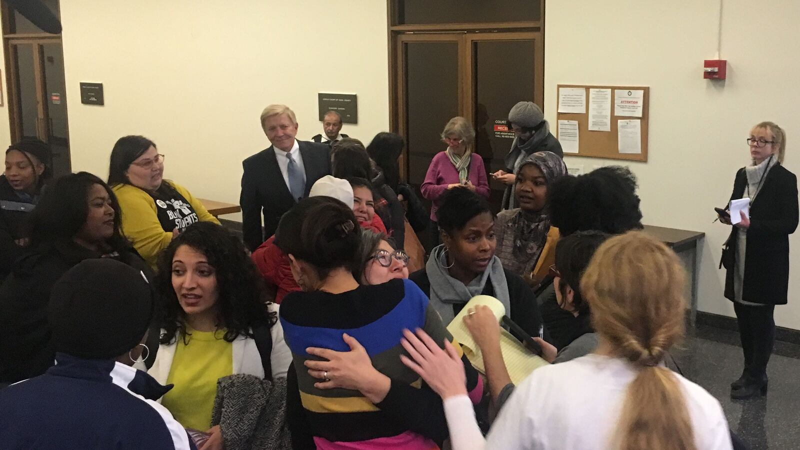 Supporters of NTA celebrate in the hallway outside the courtroom on Monday.
