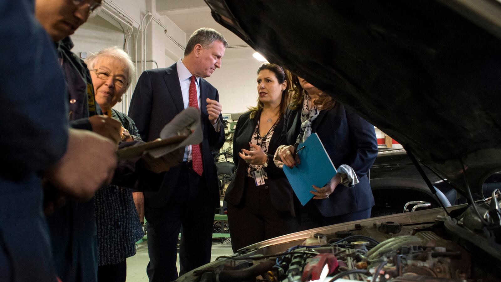 Mayor Bill de Blasio spoke in 2015 with Automotive High School Principal Caterina Lafergola, who later left the school. Automotive is one of eight schools where teachers have had to reapply for their jobs in recent years.Now, teachers at two more schools will have to do the same. (Ed Reed/Mayoral Photography Office)