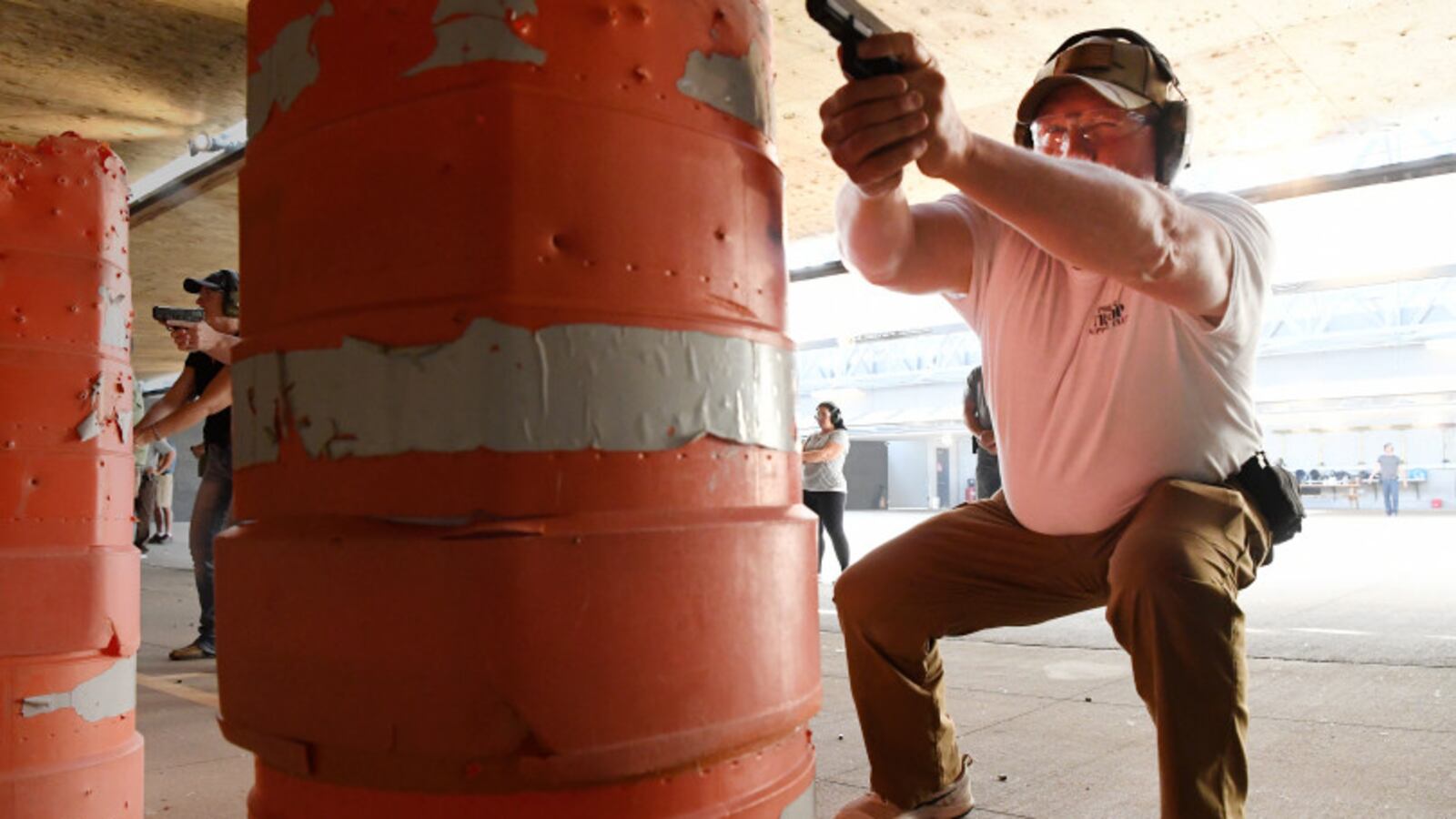 Jerry Walker, a high school principal from Oklahoma, fires his handgun on a gun range during a training session at Flatrock Training Center. (Photo by Andy Cross/The Denver Post)