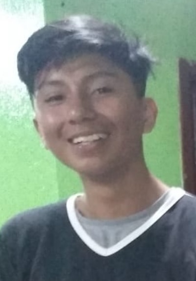 A portrait of a boy in a dark shirt.