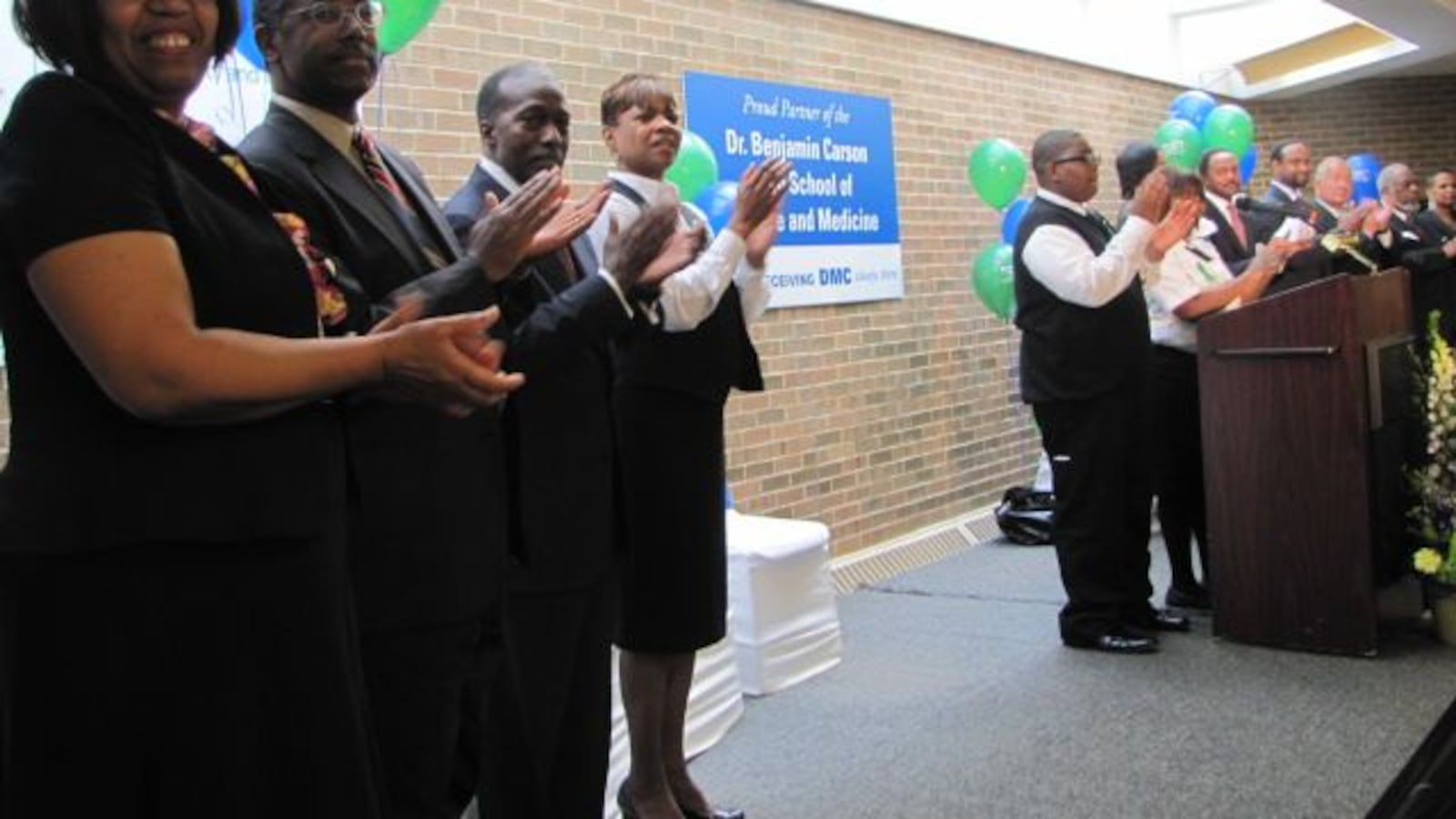 Ben Carson, second from left, and Roy Roberts, then the state-appointed emergency manager of Detroit public schools, at the 2011 ribbon cutting for the Detroit high school named after Carson.