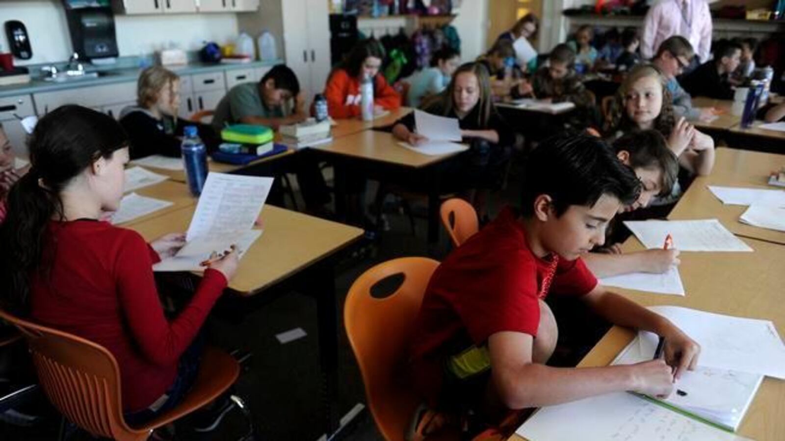 Luciano Martingano works on answering questions on a worksheet during a social studies class at Meiklejohn Elementary in Arvada.