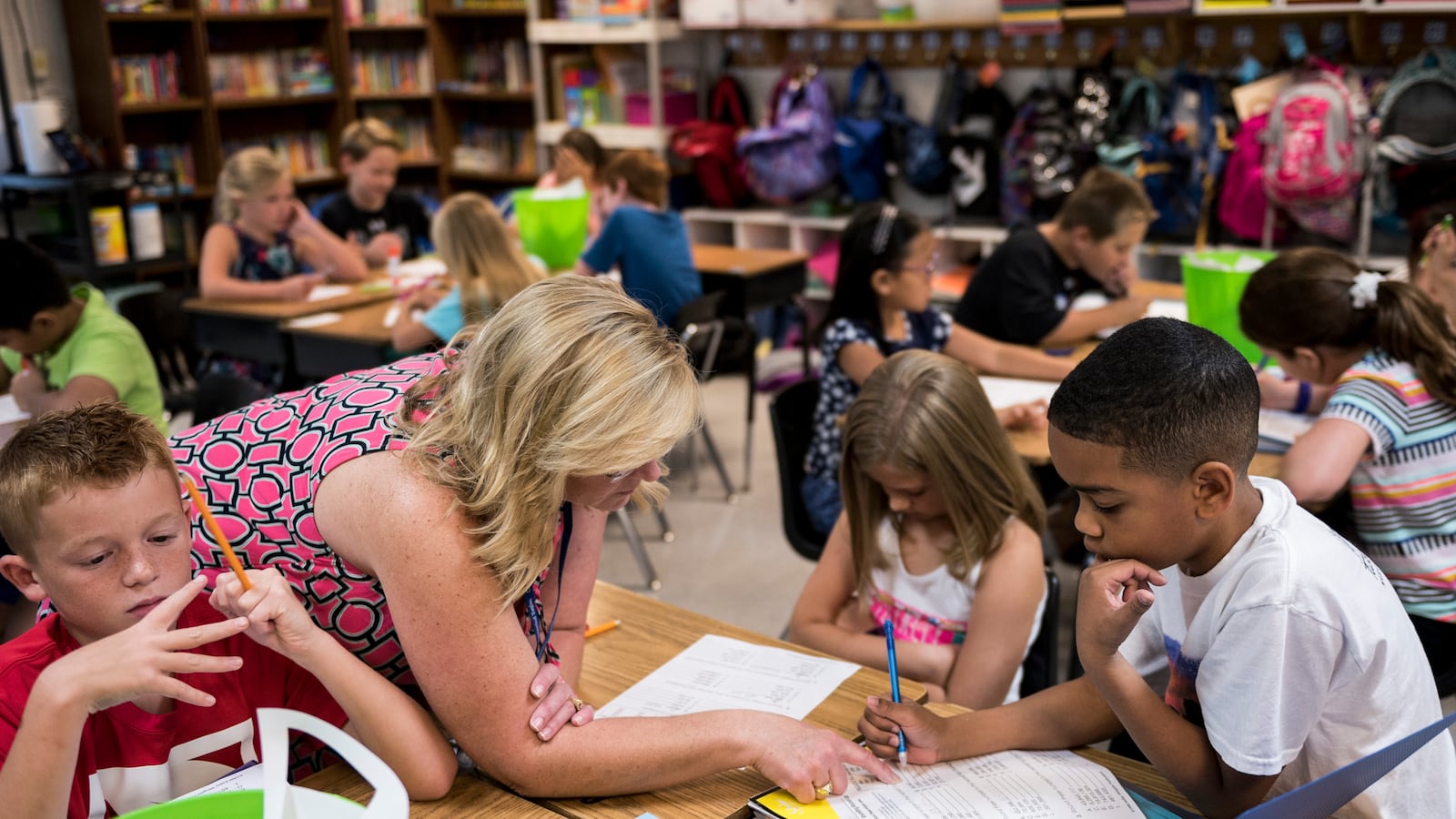 Fourth-grade teacher Stephanie Rice works with her students at Crosswind Elementary School in Collierville.