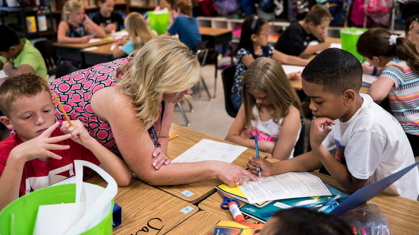 Fourth-grade teacher Stephanie Rice works with her students at Crosswind Elementary School in Collierville.