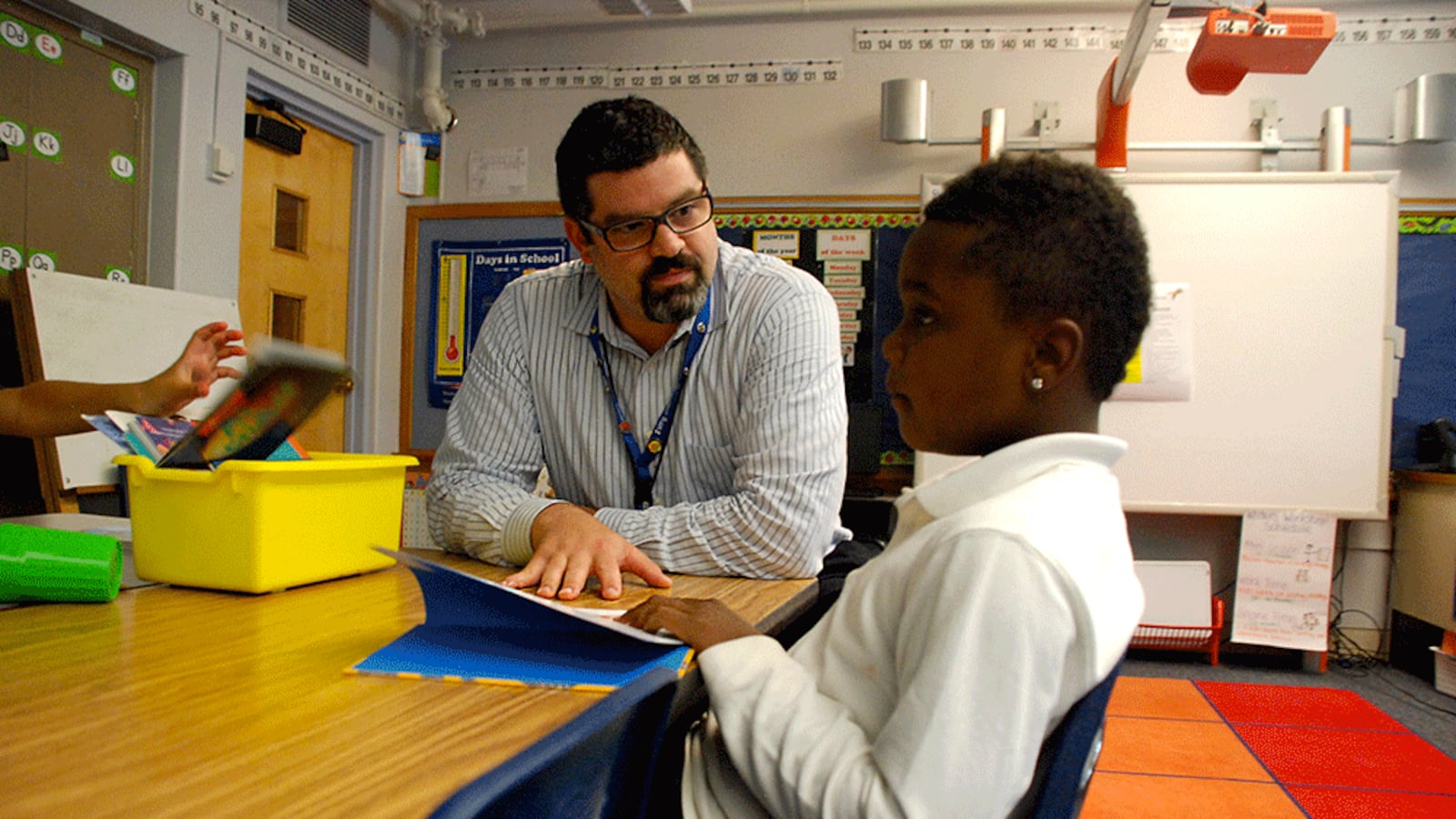 Columbine Elementary School principal Jason Krause visits with a student Wednesday. Krause was named principal of Columbine, a chronic low performing school in northeast Denver, last year.