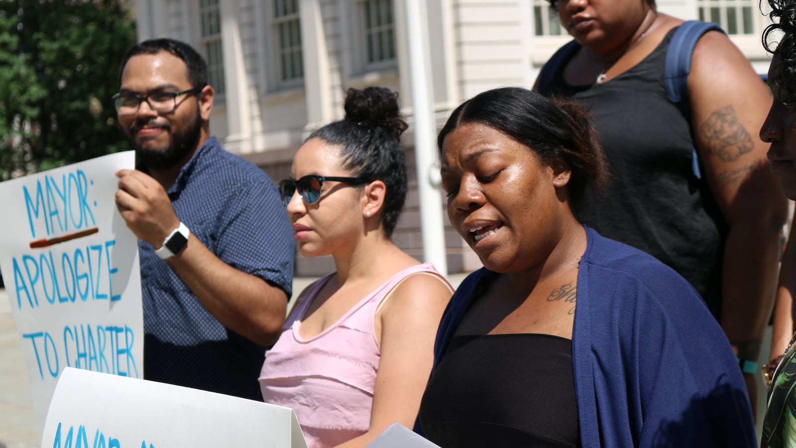 Sharita Moore-Willis, whose daughter will start first grade at Girls Prep Lower East Side this fall, speaks at a rally on the City Hall steps demanding an apology from Mayor Bill DeBlasio for his earlier comments on charter school test scores.
