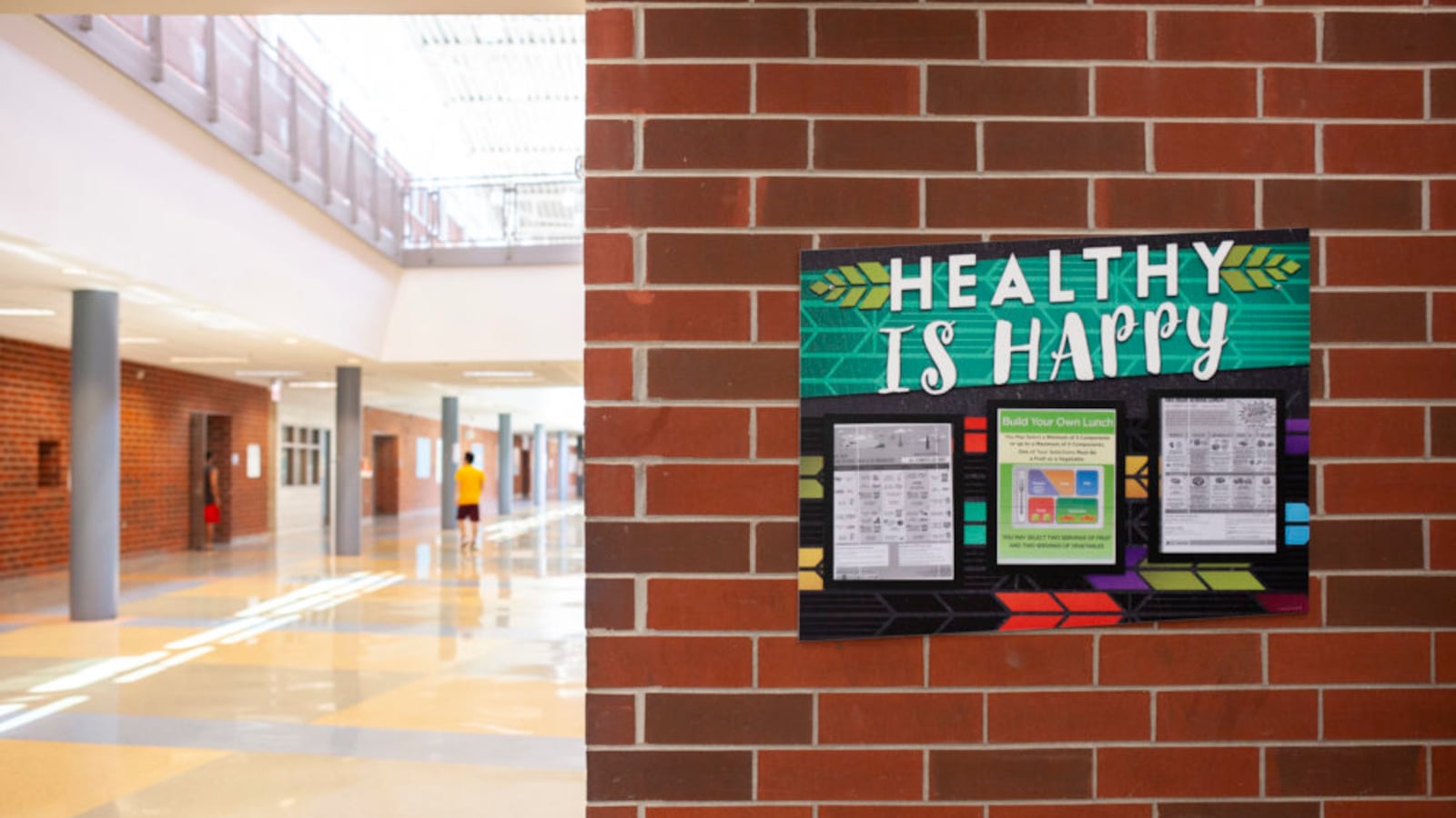 A sign on a brick wall inside North-Grand High School in Chicago says “Healthy is Happy.” 