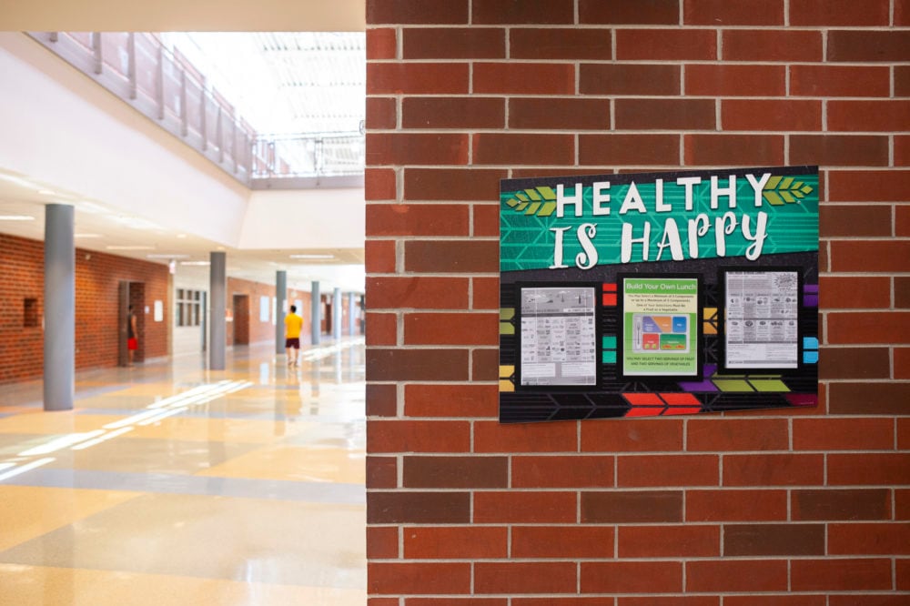 A sign on a brick wall inside North-Grand High School in Chicago says “Healthy is Happy.” 