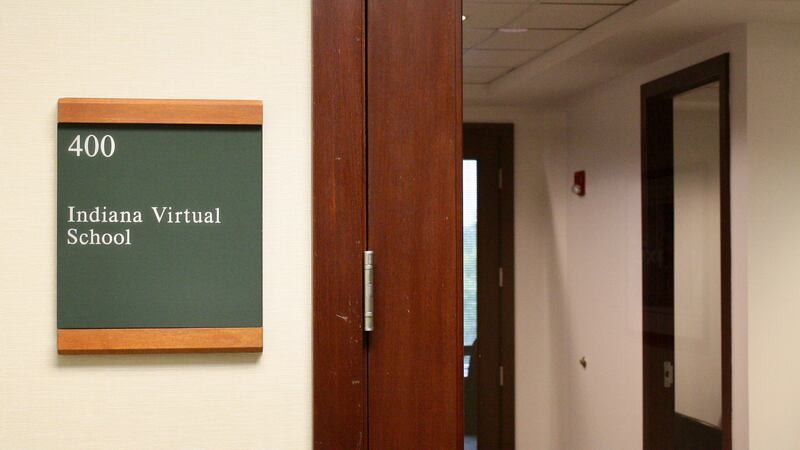 A small office sign that reads "Indiana Virtual School" is next to a door with a glass front.