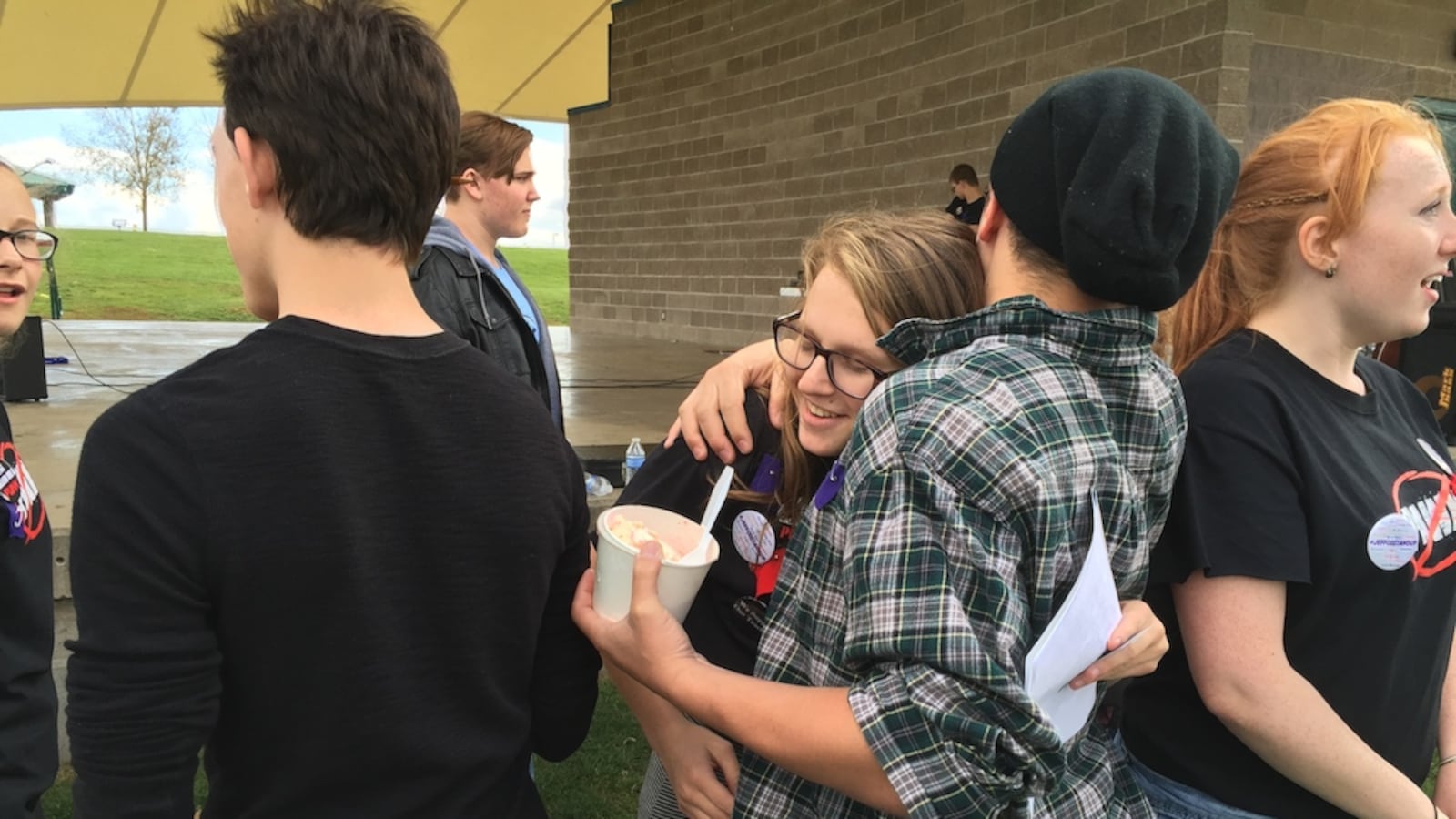 Evergreen High School student Mali Holmes, center, gets a hug from a fellow student after she spoke at a rally, organized by students, to gauge interest in a possible recall of three Jefferson County board members.