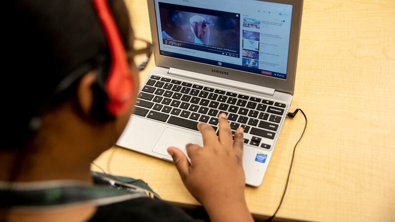 A student works on a laptop computer during a special education classroom exercise.