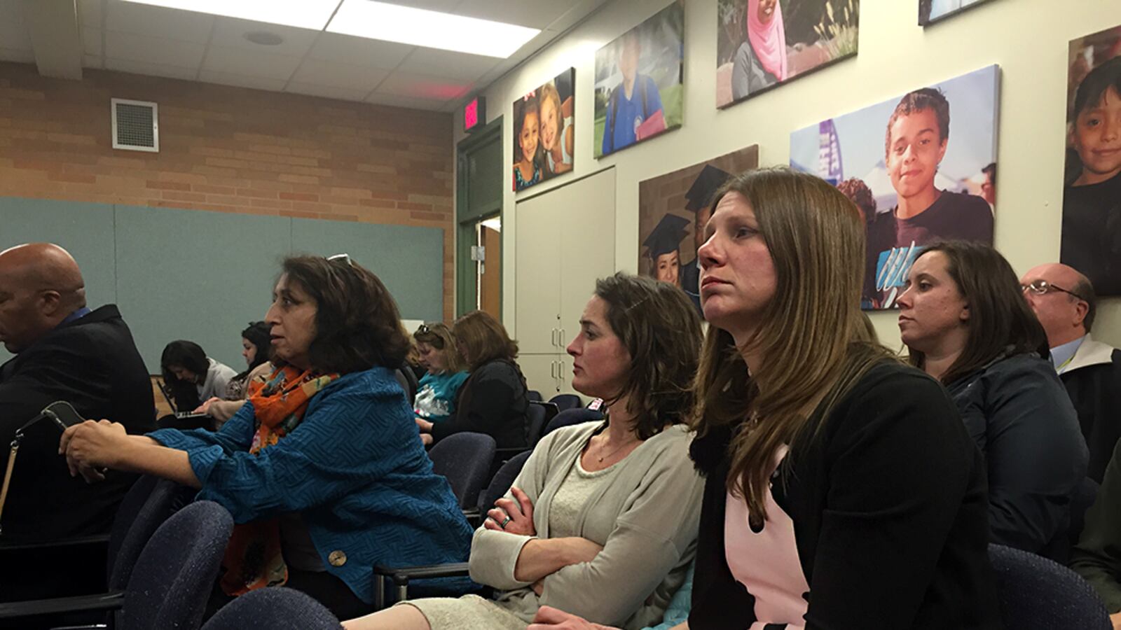 Boston K8 Principal Ruth Badivia, left, with Crawford Elementary School Assistant Principal Jennifer Buster and Jenny Passchier listen to the Aurora school board before it voted on their schools redesign plans.
