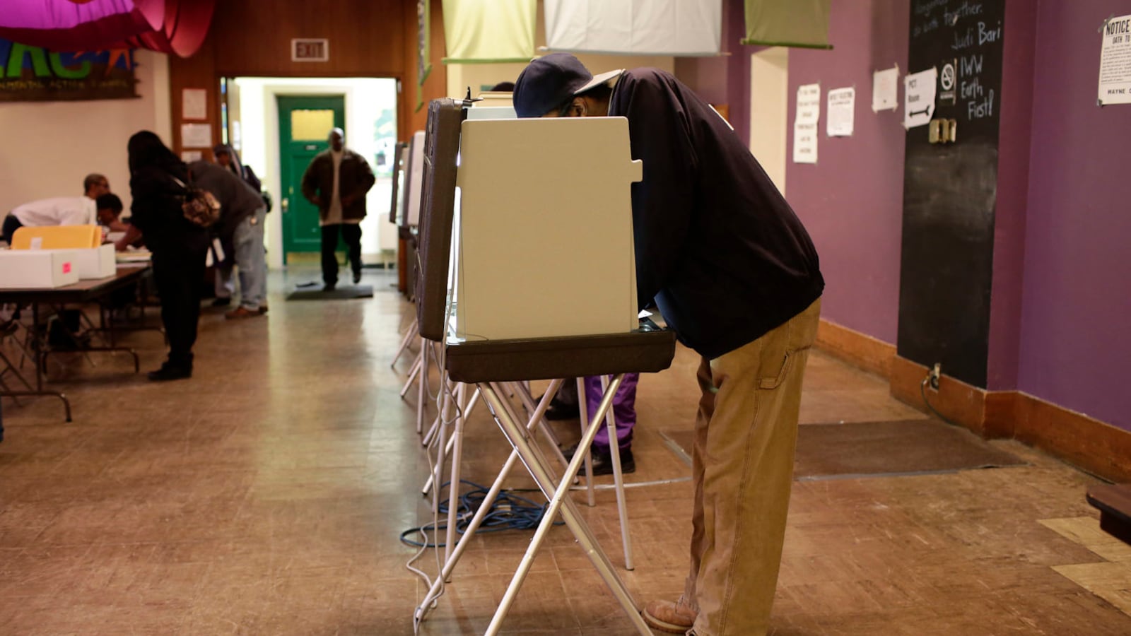 A man fills out his ballot at a polling station during the midterm elections Nov. 4, 2014 in Detroit.