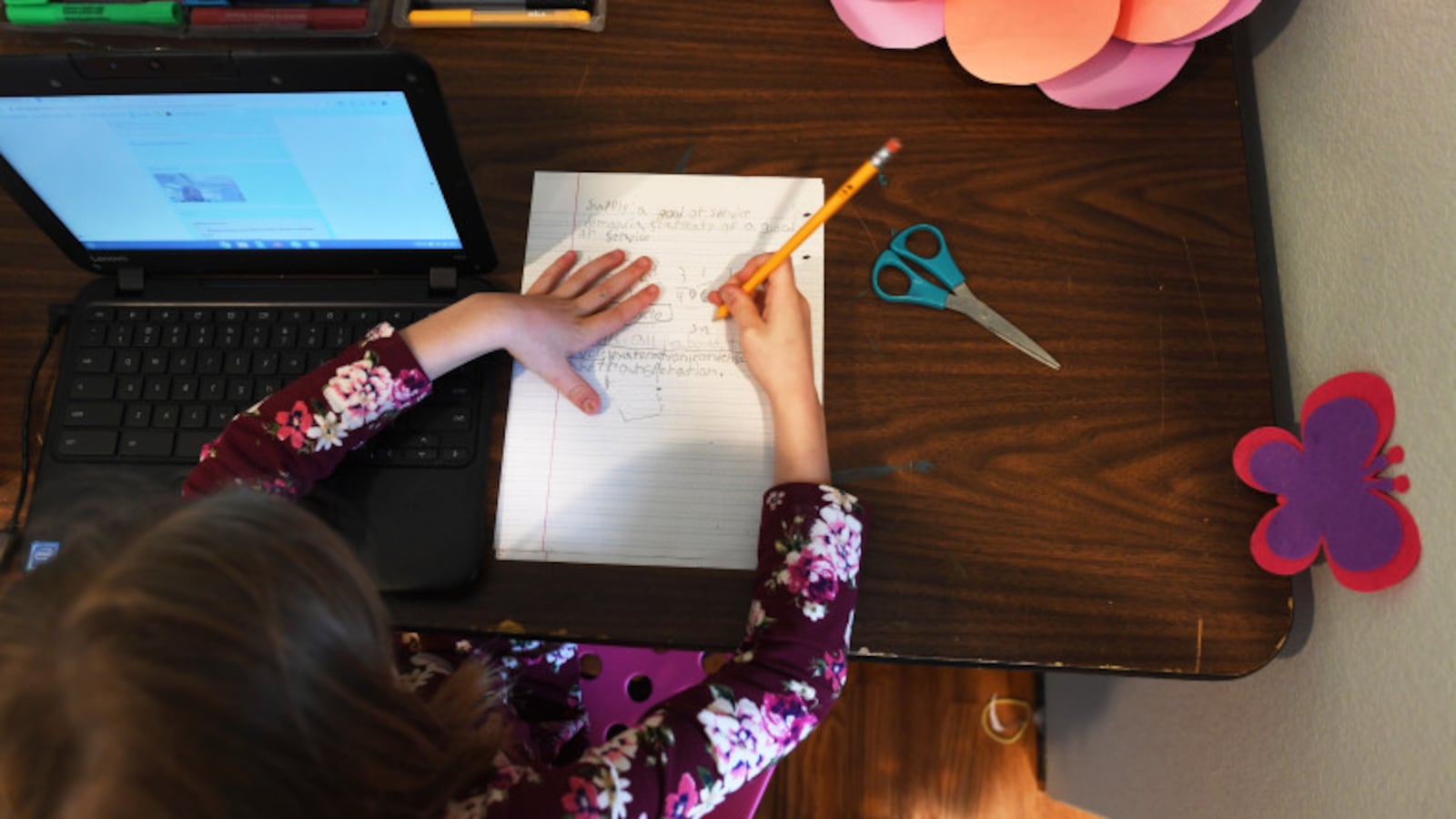 A student works on classwork in her room in Denver.