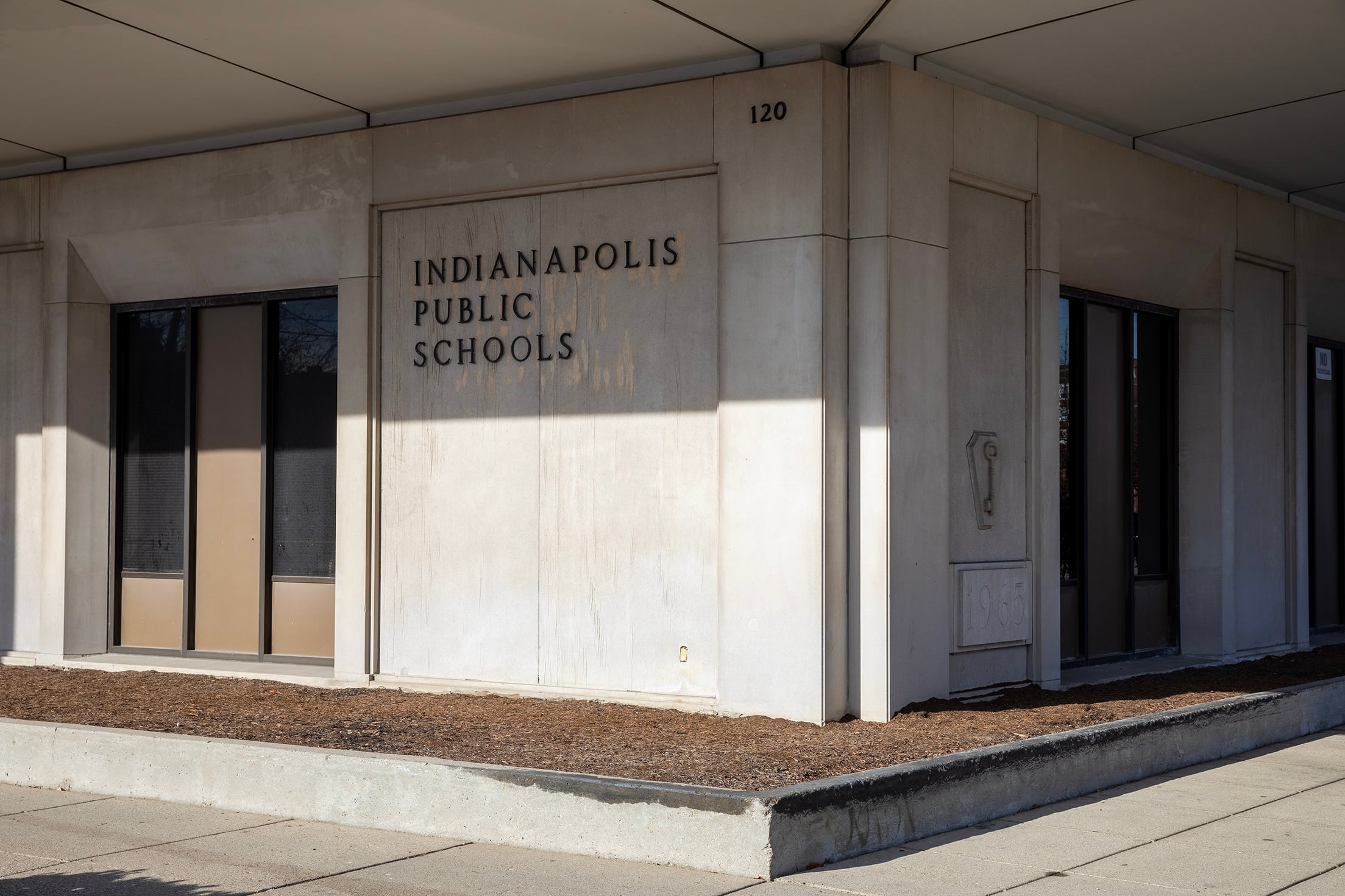 The side of the tan building with words that read "Indianapolis Public Schools."
