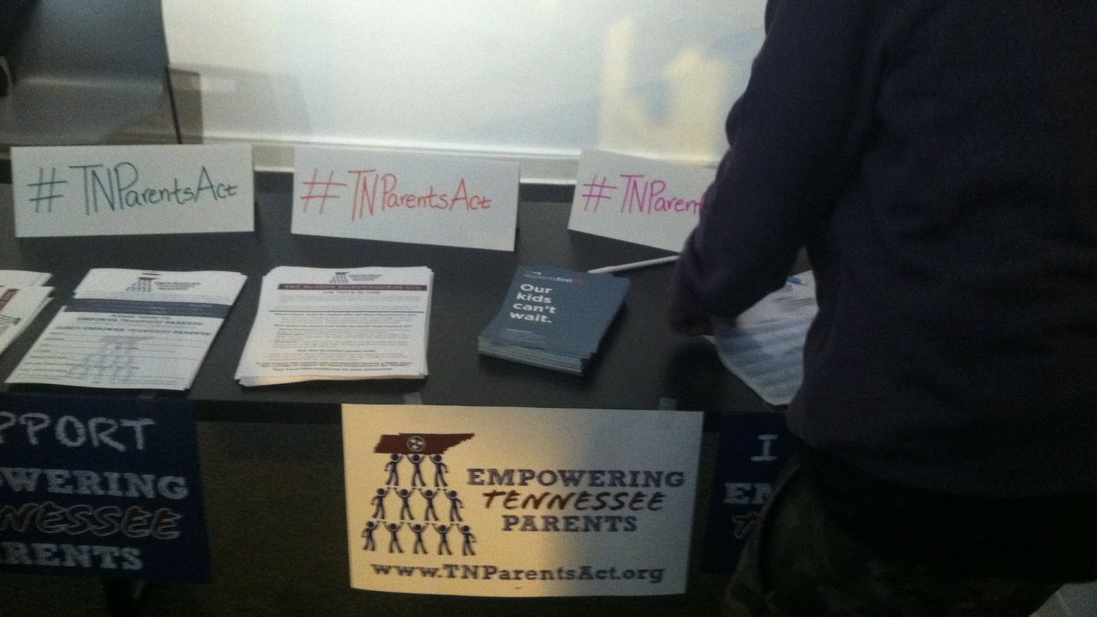 A table set up at a screening of a documentary about the parent trigger act.