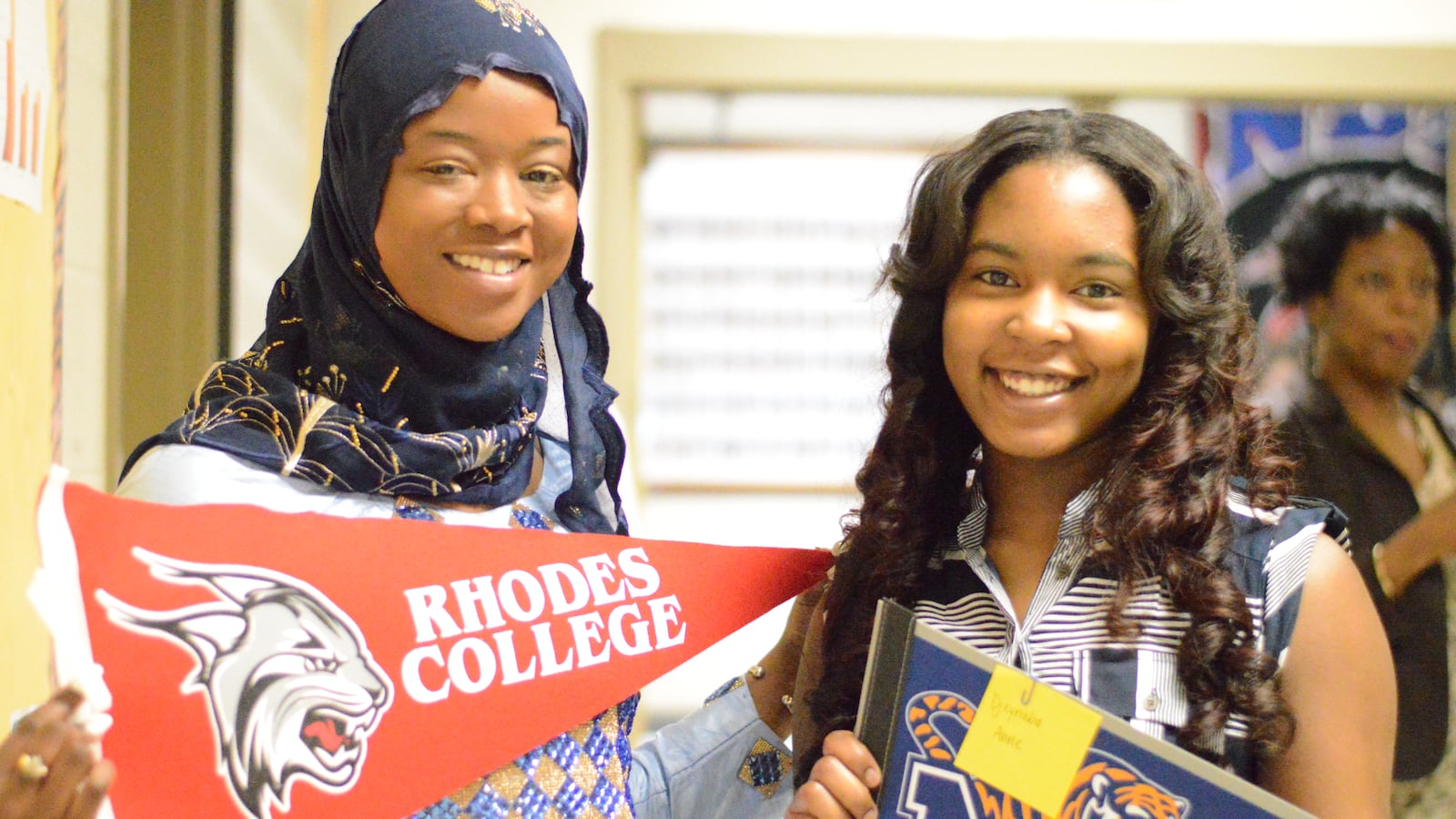 From left: Fatimata Deme and Djeynaba Anne proudly show off their college choices during Academic Signing Day at Whitehaven High School in Memphis.