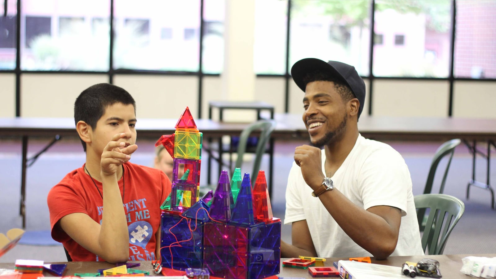 A teacher and a student at The Laradon School in Denver work together with tactile teaching tools.