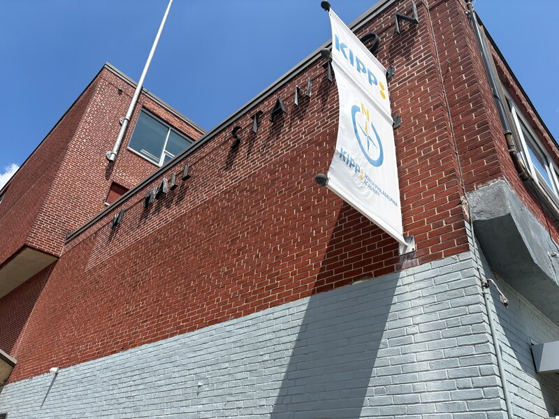 A photograph of part of a brick school building outside.