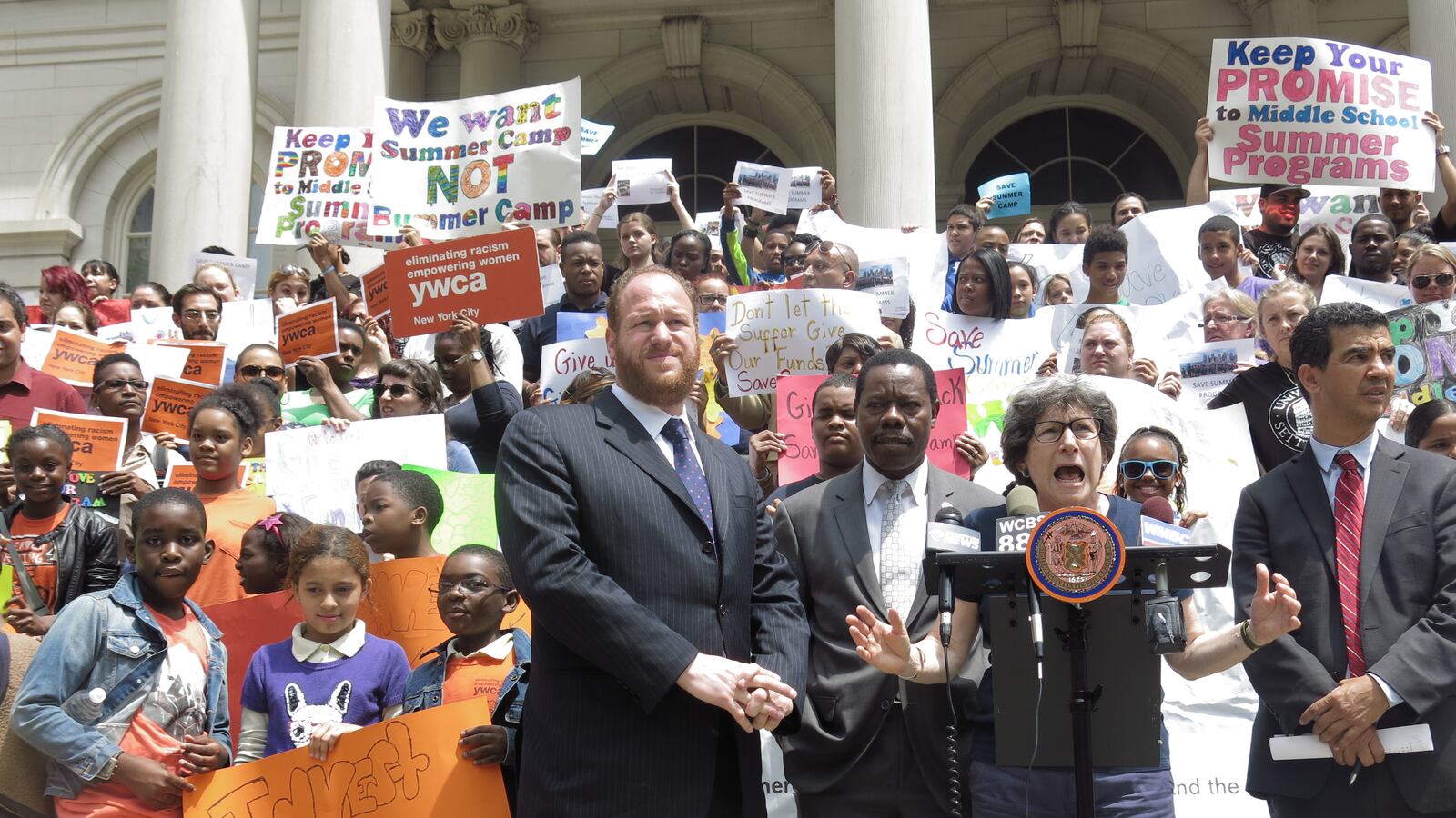 Summer program providers rallied outside City Hall on Thursday.