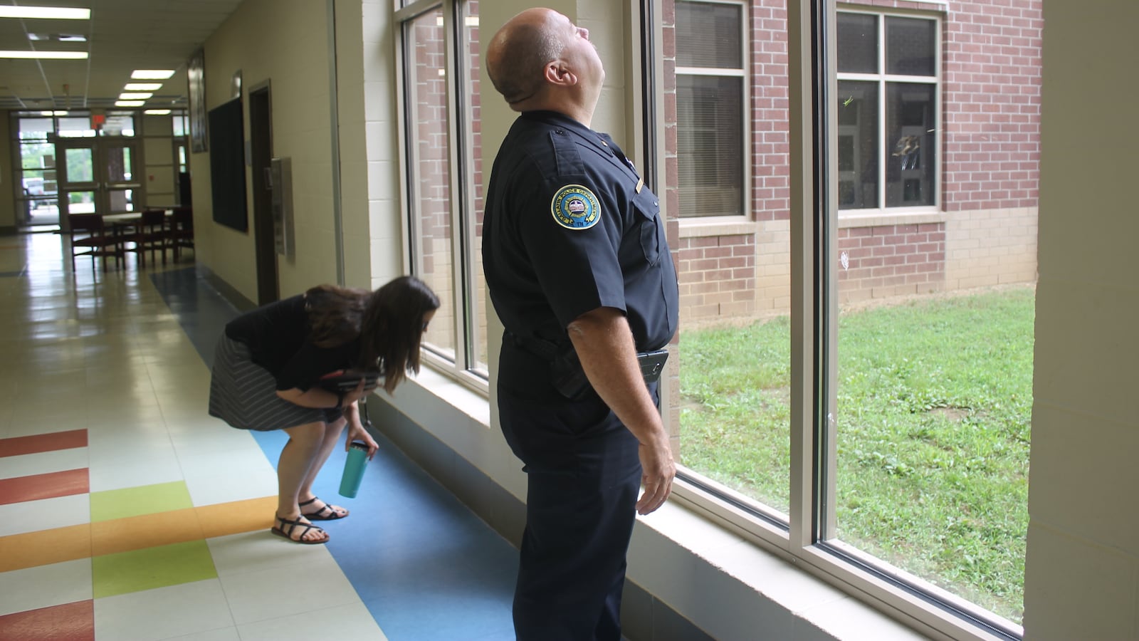 Sumner County Schools safety coordinator Katie Brown and Lt. Billy Vahldiek of Gallatin police examine the window pane in a school hallway to make sure the glass is shatter-resistant. The review team is one of more than a hundred across the state who conducted security assessments over the summer of every Tennessee public school.