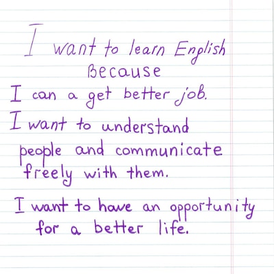 A photocopy of a ruled white piece of paper with purple writing.
