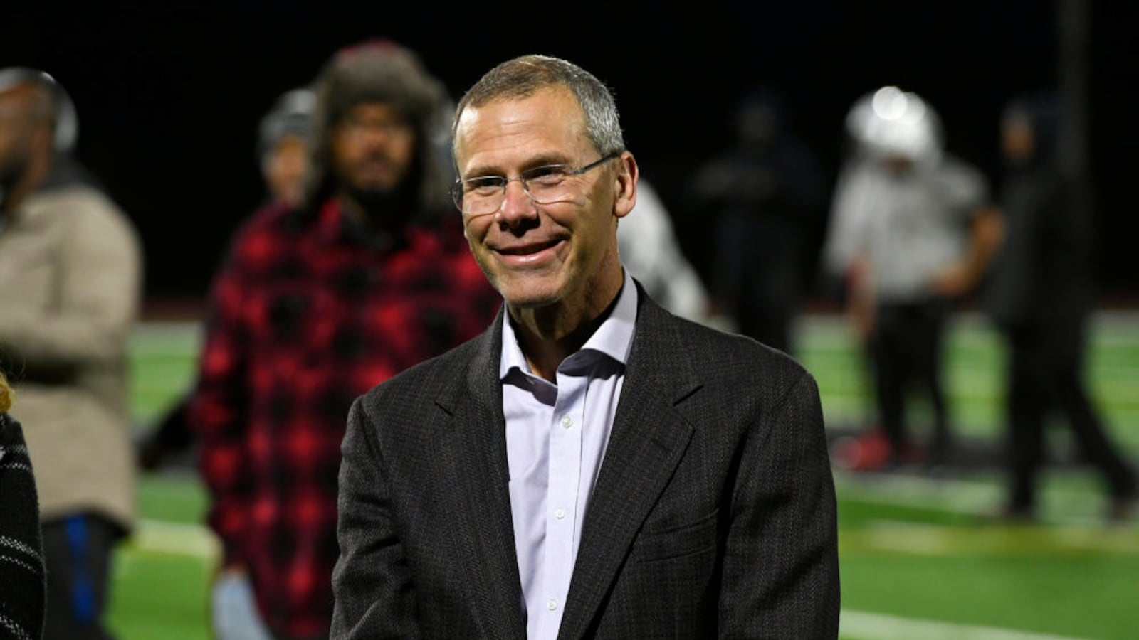 Denver Public Schools Superintendent Tom Boasberg smiles as he checks out the new lights on the football field at the Montbello campus earlier this month.