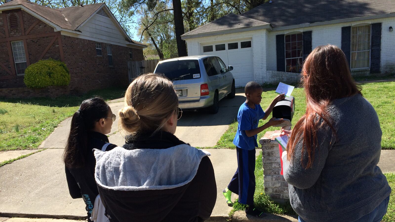 Staff members of Green Dot Public Schools canvass a neighborhood near Kirby Middle School in the summer of 2016 before reopening the Memphis school as a charter.