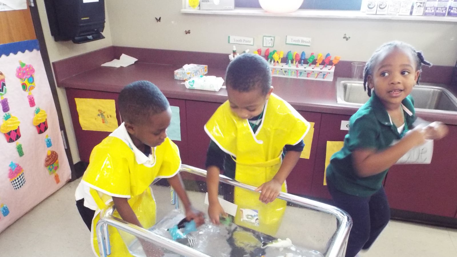 Two boys splash in the “ocean,” a large aquarium-like container half-filled with water and tiny plastic sea creatures, in a prekindergarten class at Lucie E. Campbell Elementary in Memphis.