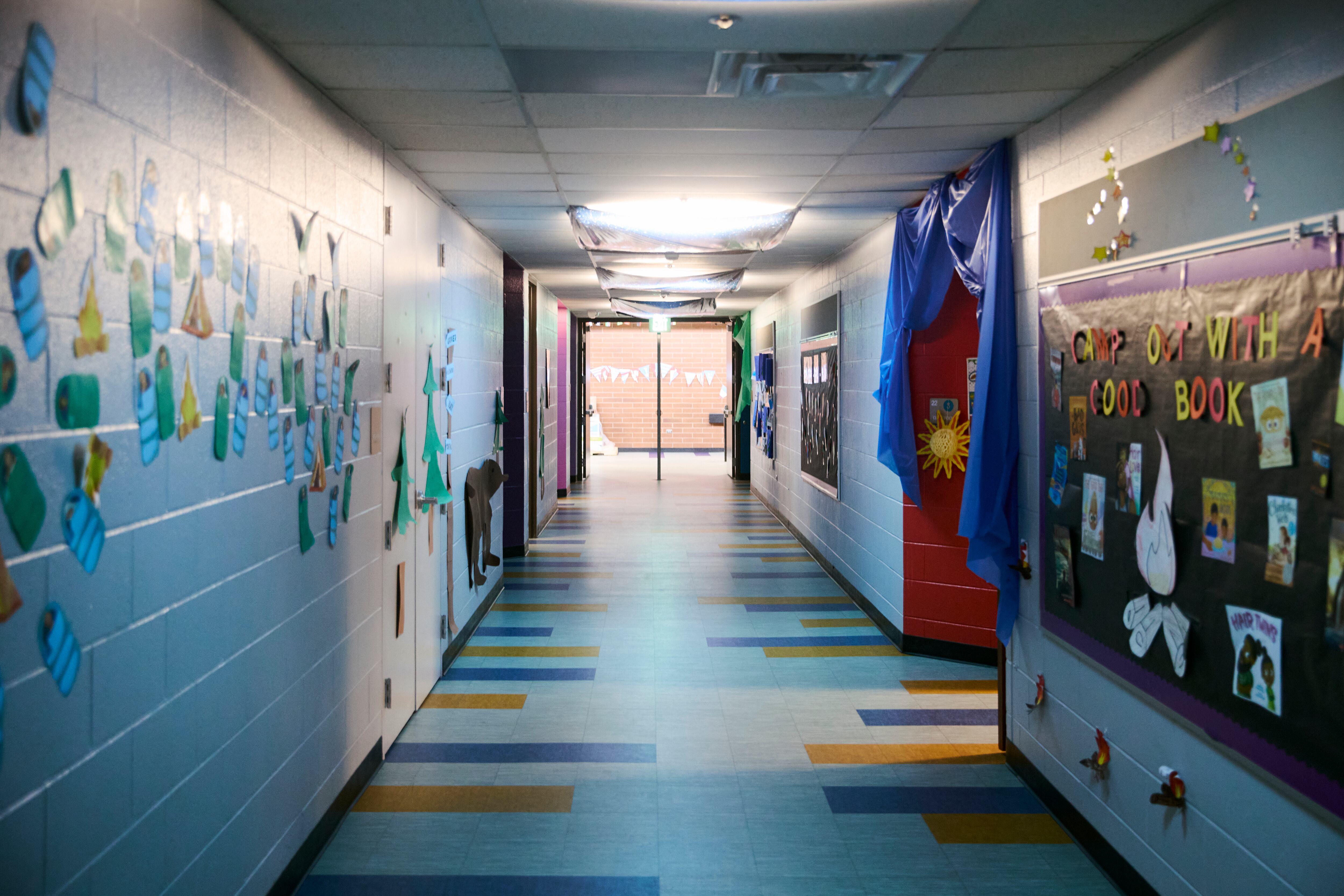 A photograph of an empty colorful school hallway.