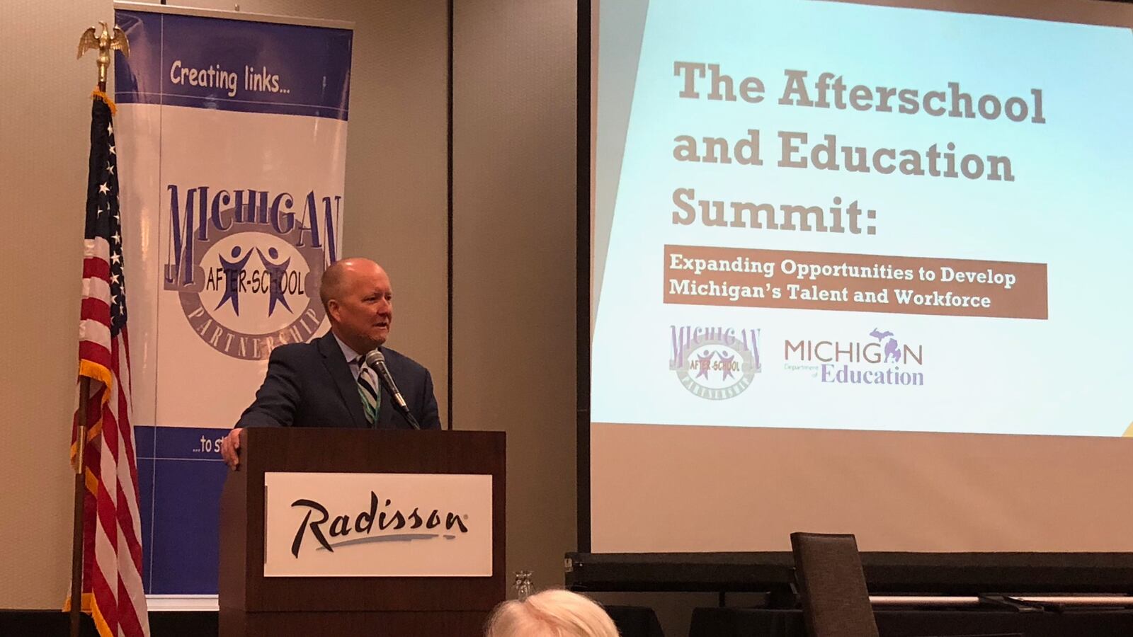 Matt Gillard, president of advocacy group Michigan's Children, addresses advocates in Lansing on April 16.