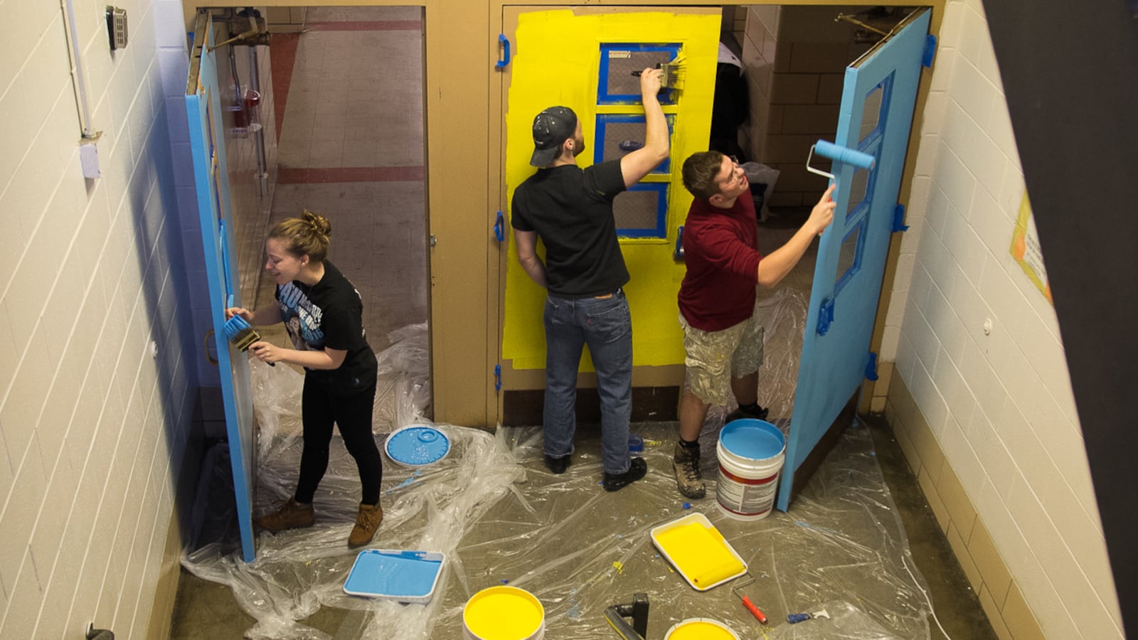 Volunteers painting at McMichael school.