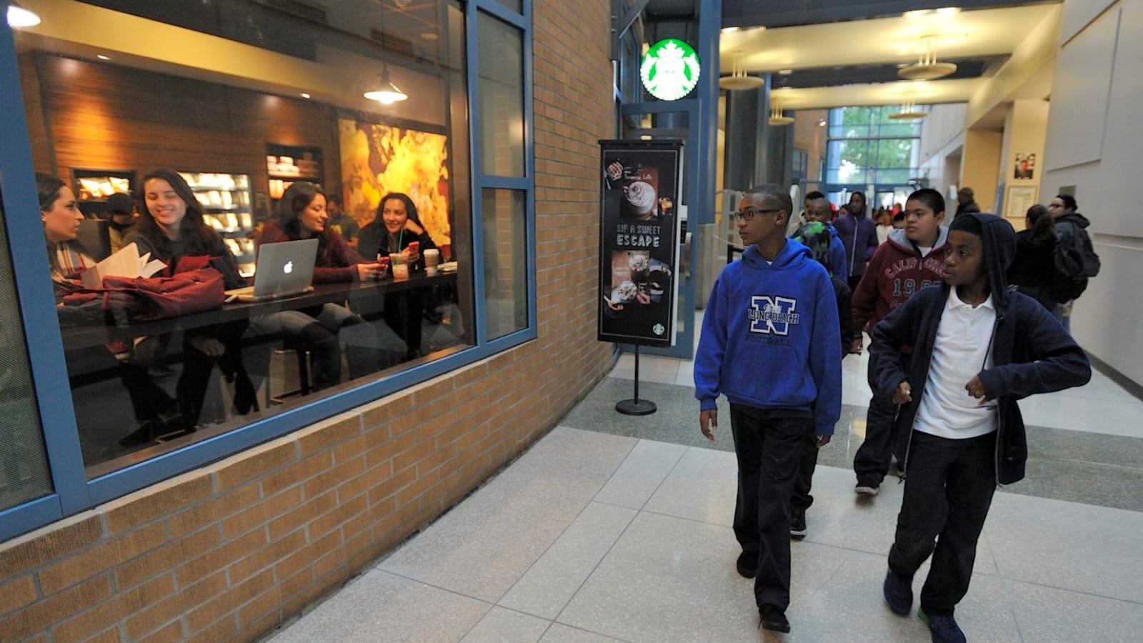 Students from Willowbrook Middle School walk through the library atrium at during a visit to Cal State Fullerton.