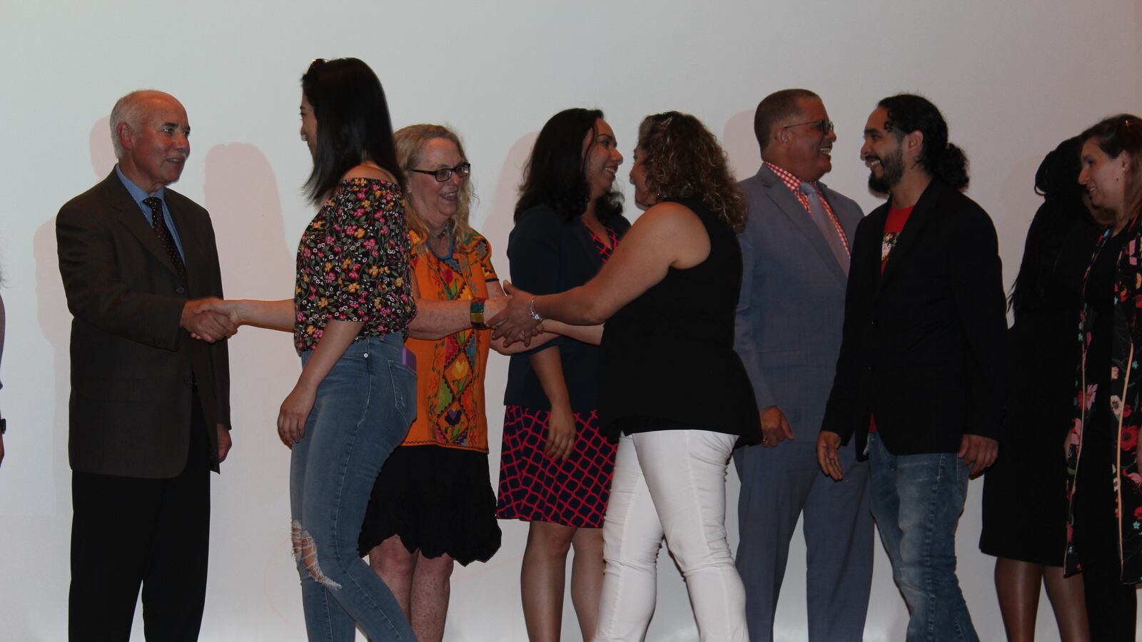 Chicago School Board President Miguel Del Valle greets parent mentor graduates on Thursday, June 6, 2019.