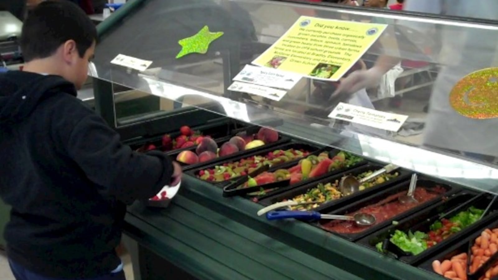 A student at Lowry Elementary chooses fresh fruit from his school's salad bar.