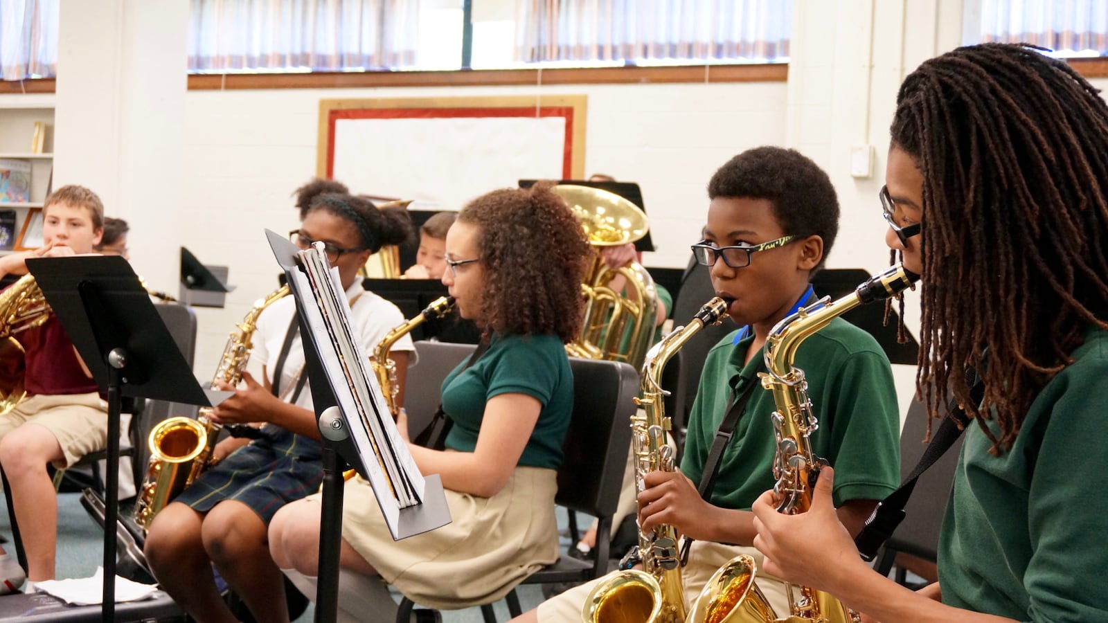 Students at the Oaks Academy in Indianapolis, a private school, play during music practice. The Oaks accepts tax credit scholarships.