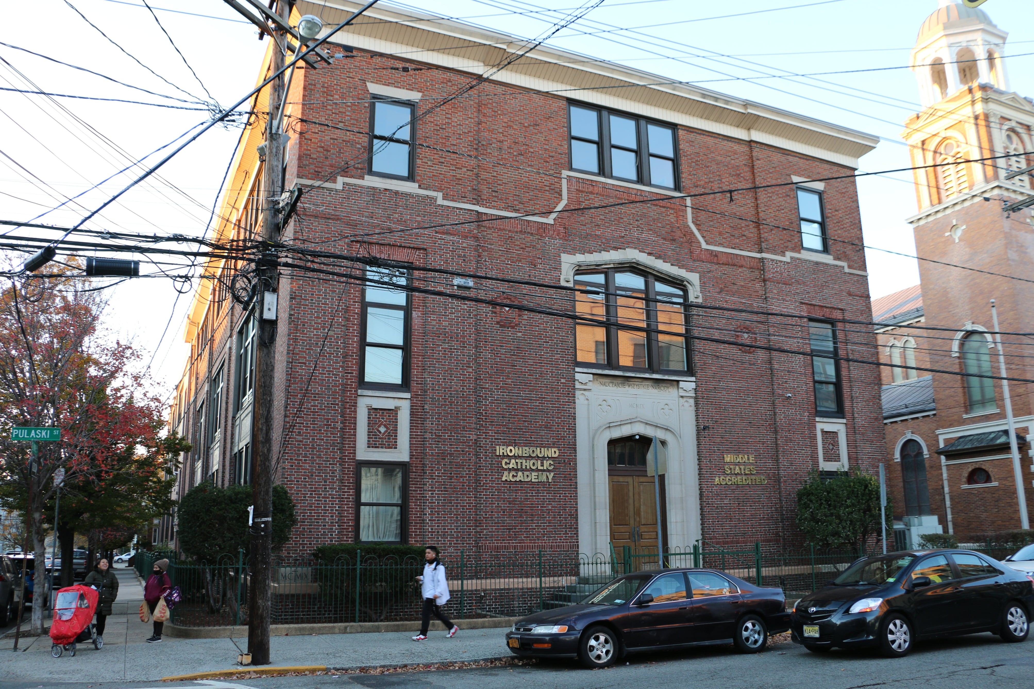 A brick building with white trim around the door and windows.