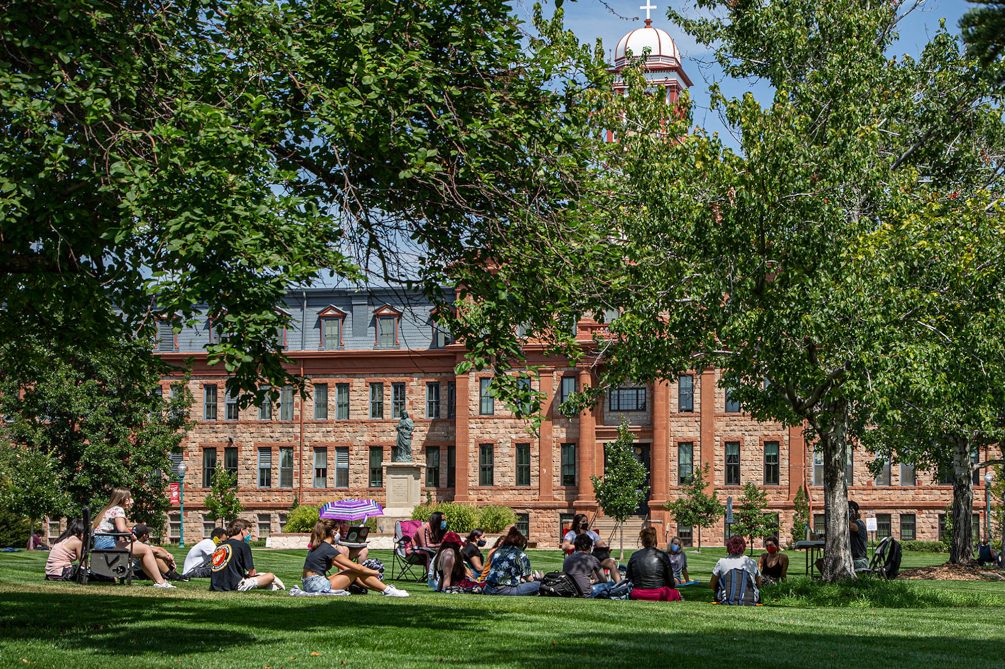 Regis University students gather outside for class during the first week of the 2020 fall semester.