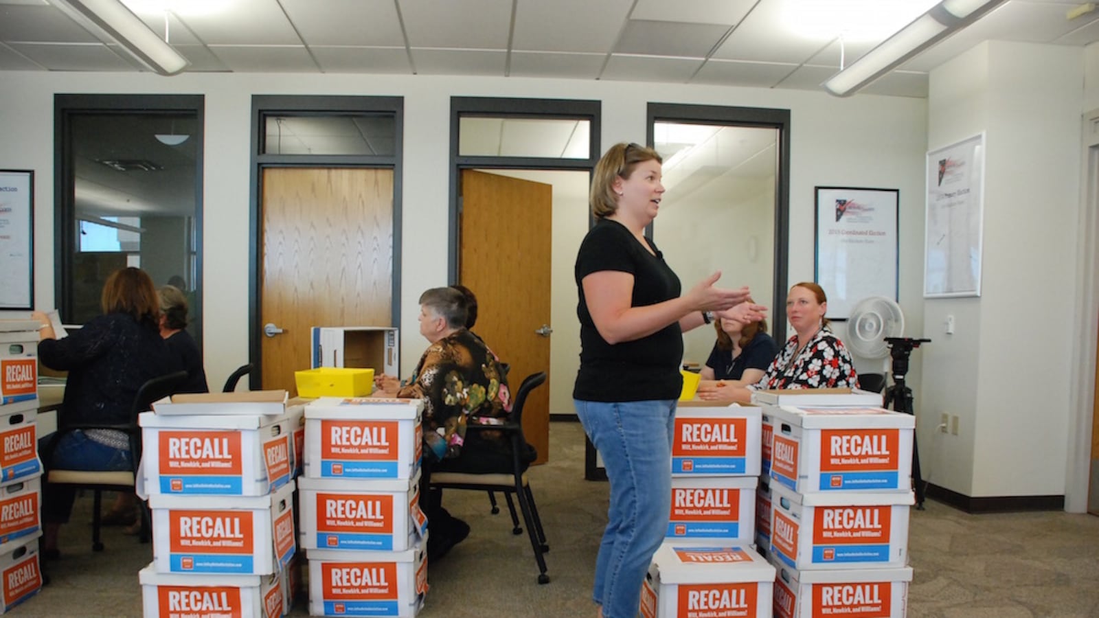 Jeffco United for Action organizer Wendy McCord speaks to the news media Wednesday while employees of the Jefferson County Clerk and Recorder's office begins processing recall petitions. Supporters of the recall effort believe they have double the number of signatures needed to put the recall question on the ballot.