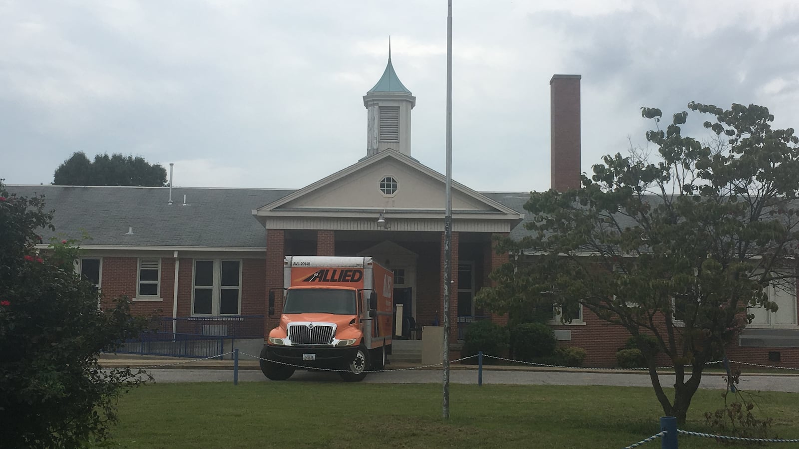 A moving van sits outside of Georgian Hills Achievement Elementary School. The state-run school relocated to a different ASD school because of roof damage, and the two schools will now share a principal.
