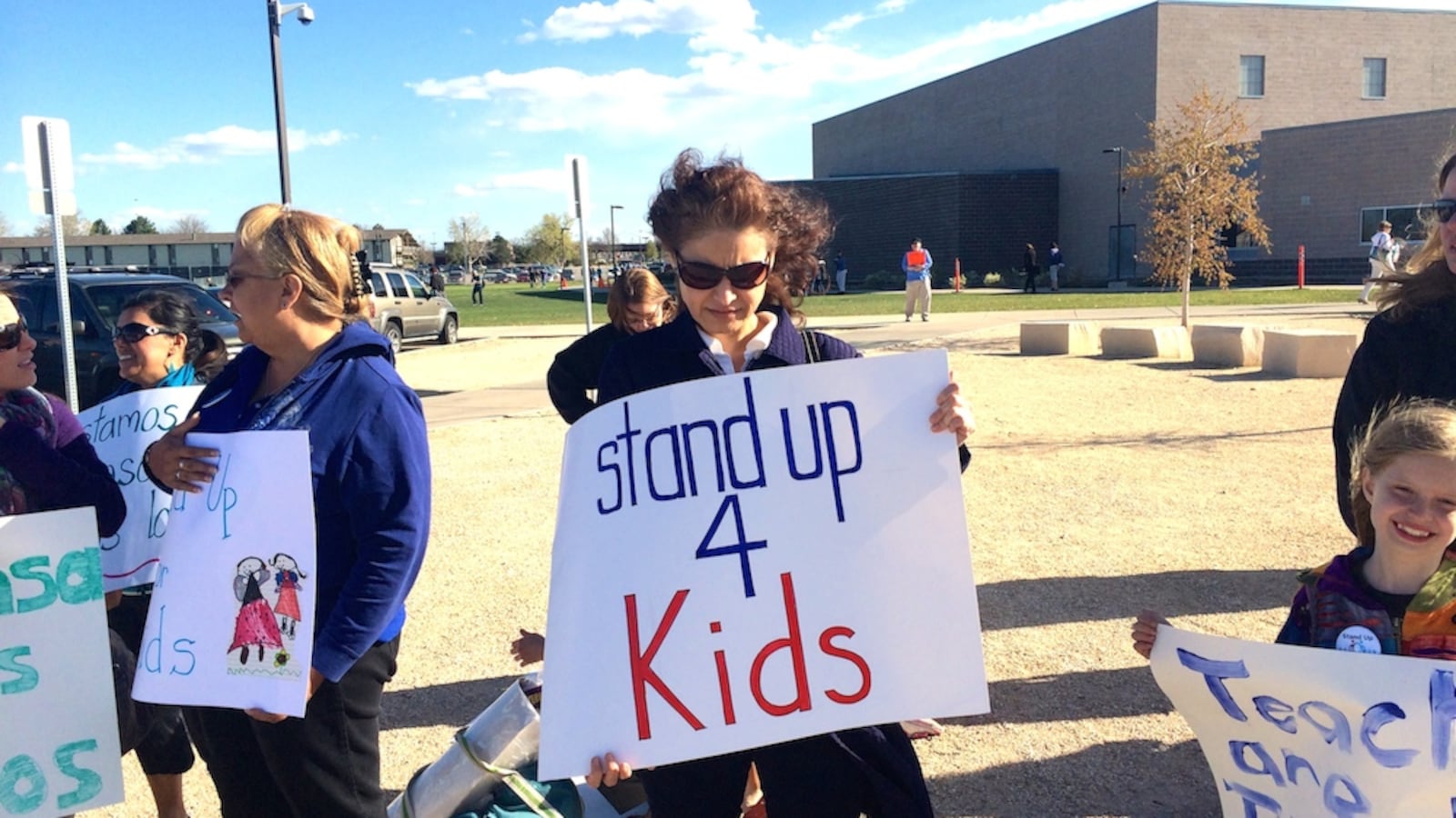 A Jefferson County resident demonstrates in front of Bear Creek High School in Lakewood Thursday. The rally was of about 400 individuals was organized largely by the Jeffco teachers union. The union and the district are in the midst of tense contract negations.