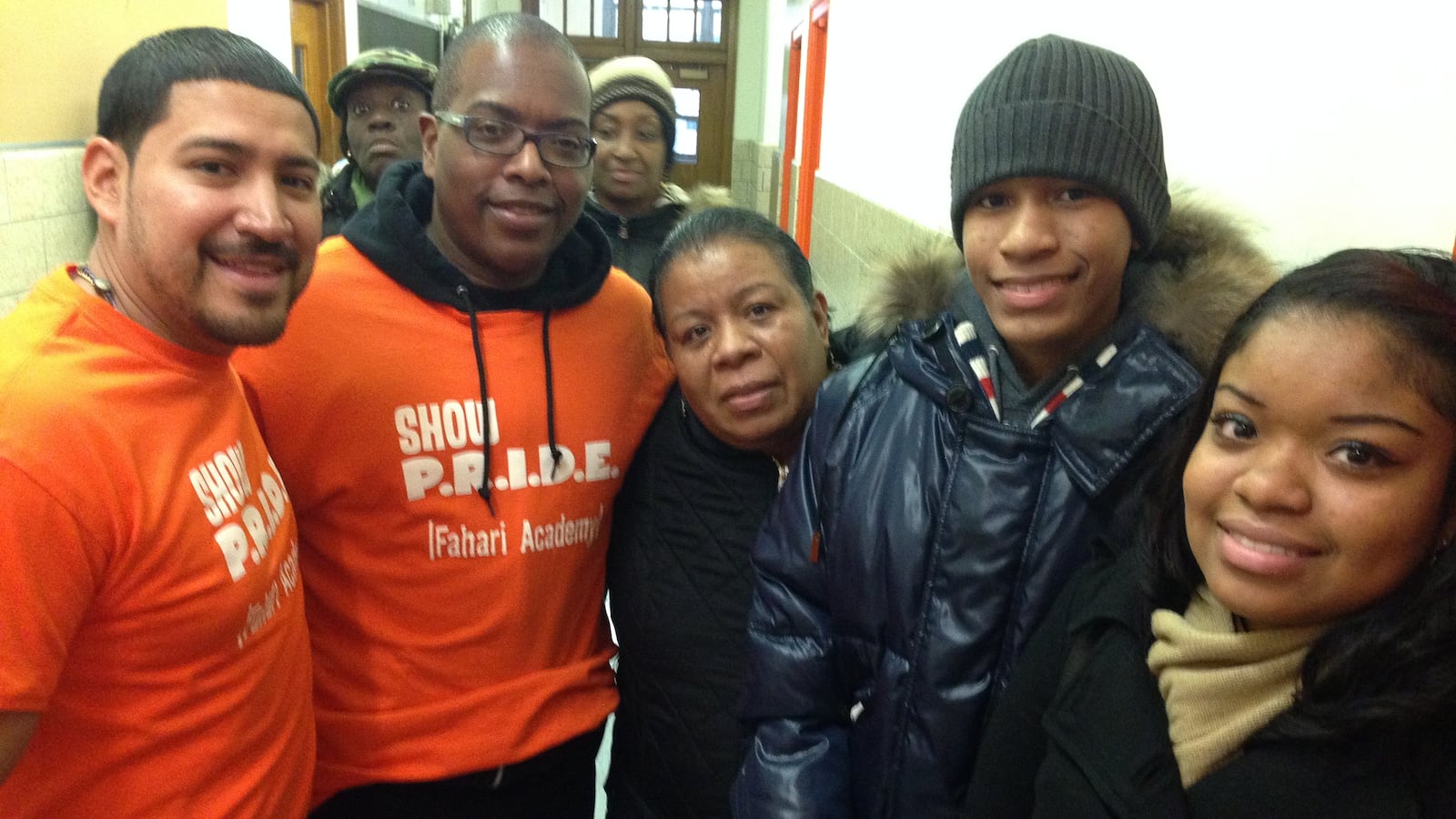 Nimia Gutierrez (center), with school staff (left), her daughter and her eighth grade son.