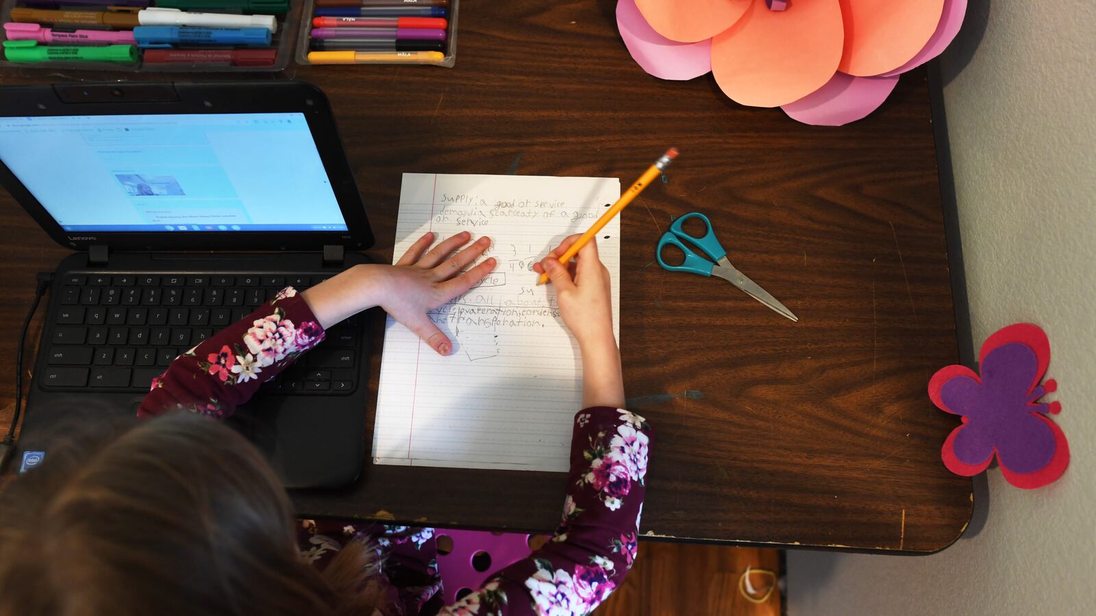 A third-grade student works at home on a computer after her Colorado school closed due to concerns about the new coronavirus.