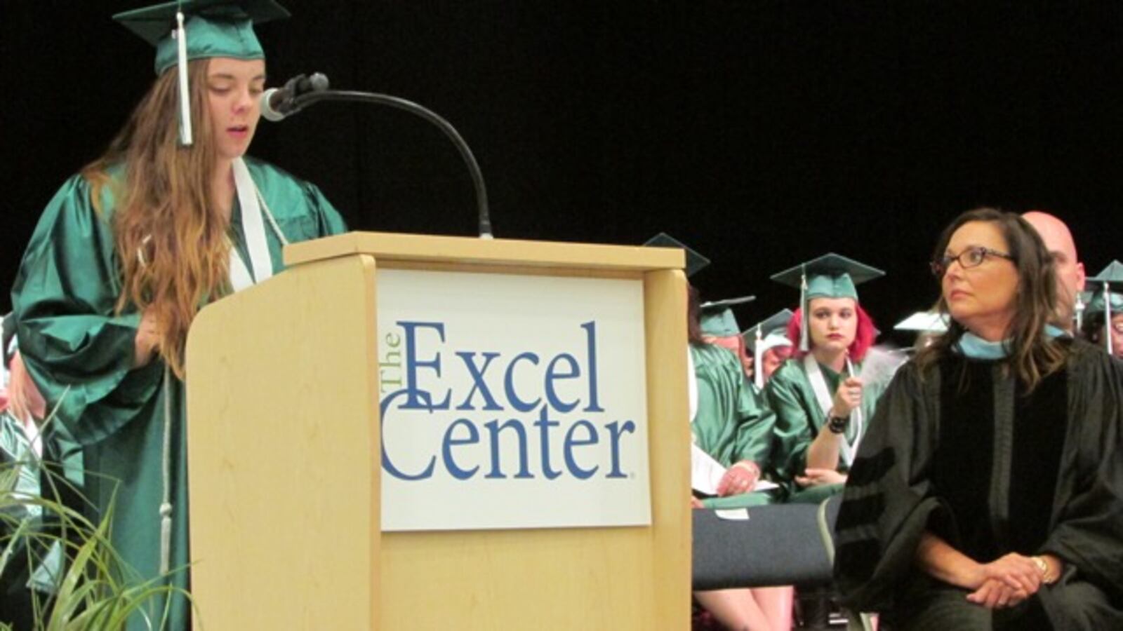 Excel Center graduate Heather Brown speaks to her classmates.