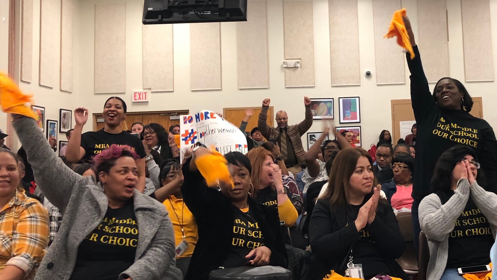 Supporters celebrate a unanimous vote from the Shelby County Schools board to keep open three charter schools.