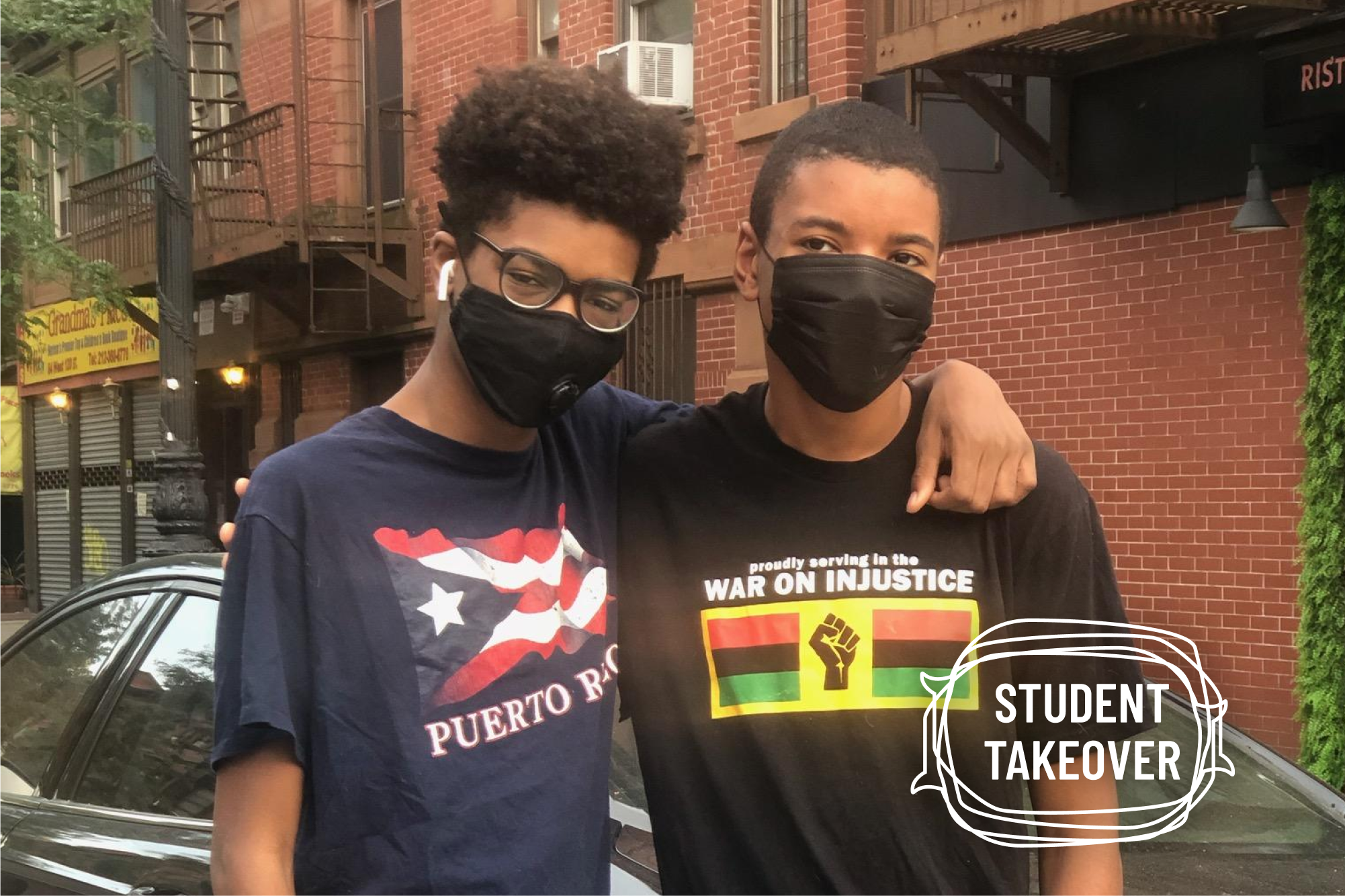 Brothers, Hudson and Hunter Russell-Horton standing side by side wearing black facemasks. Hunter has his arm around his brother Hudson.